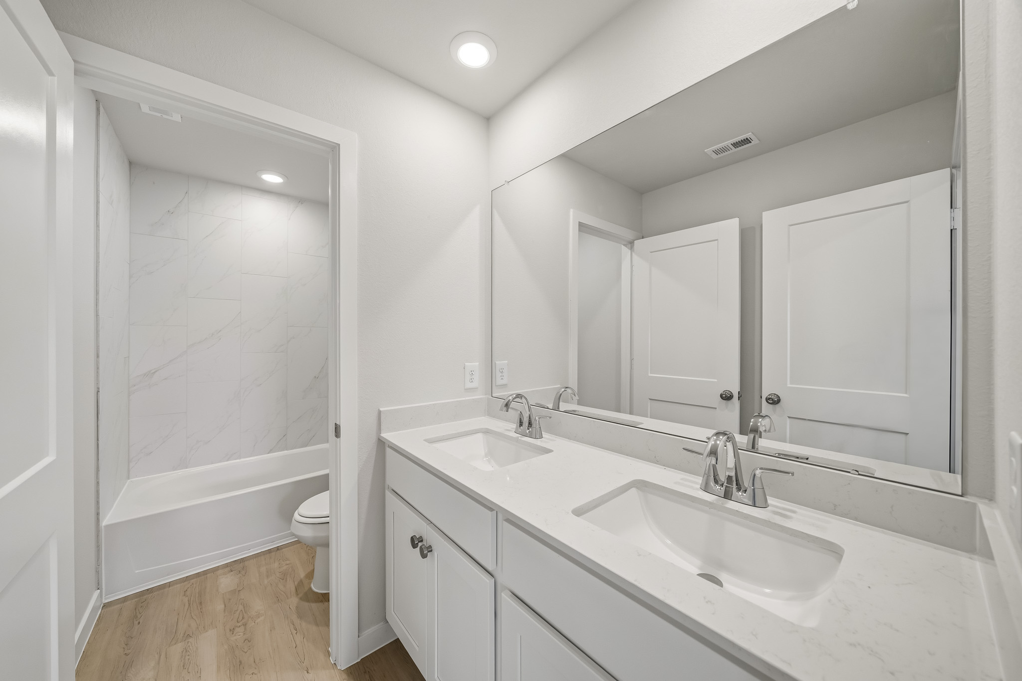 A bathroom with a tub sink and toilet.