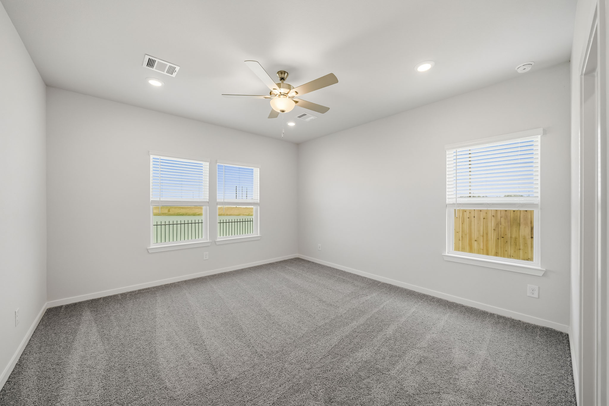 A room with a ceiling fan and a ceiling fan.