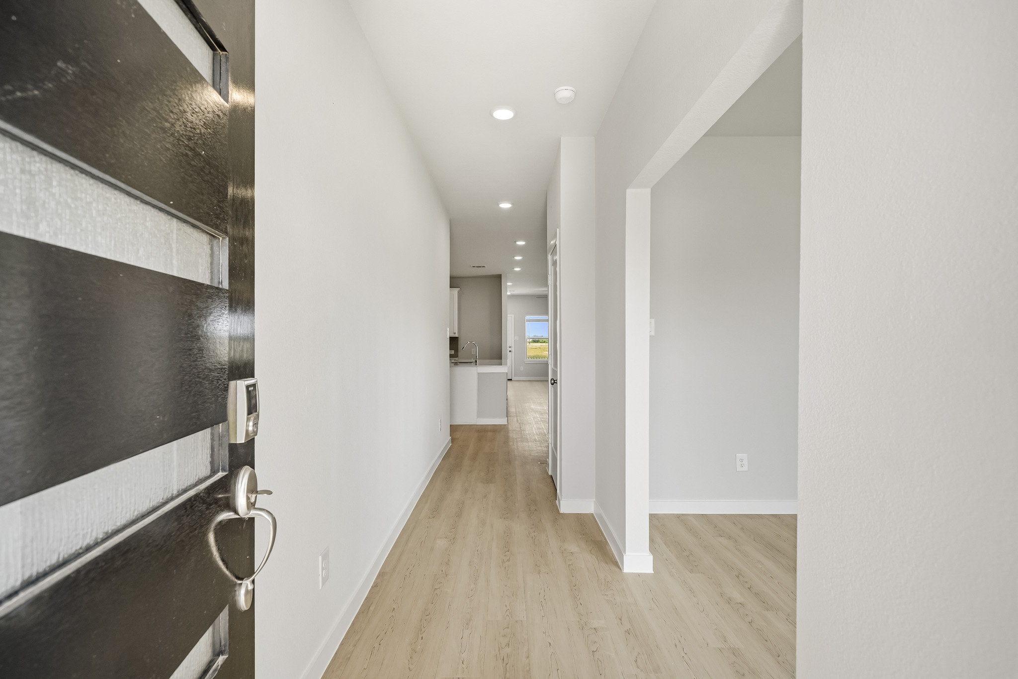 A hallway with white walls.