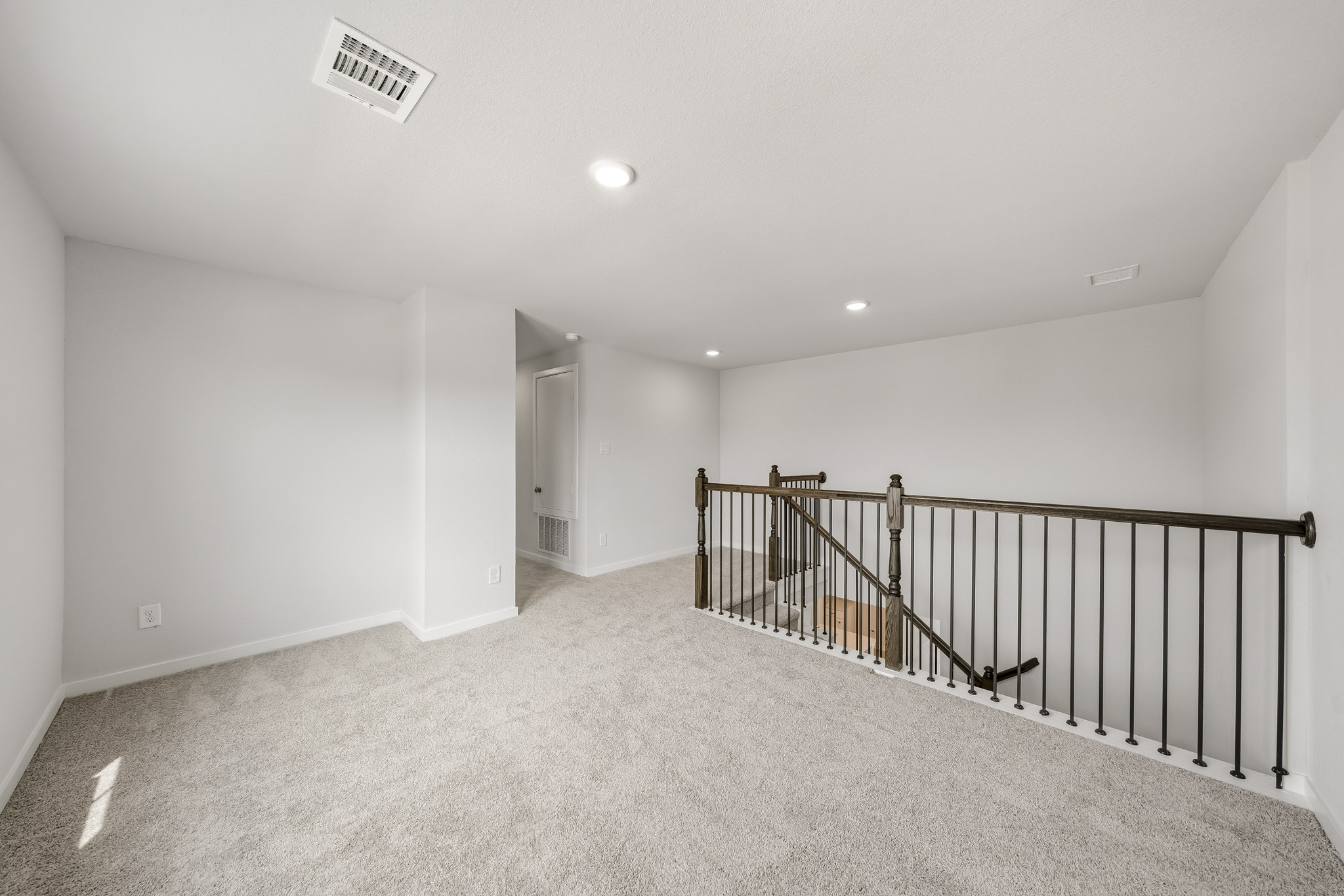A hallway with a railing.