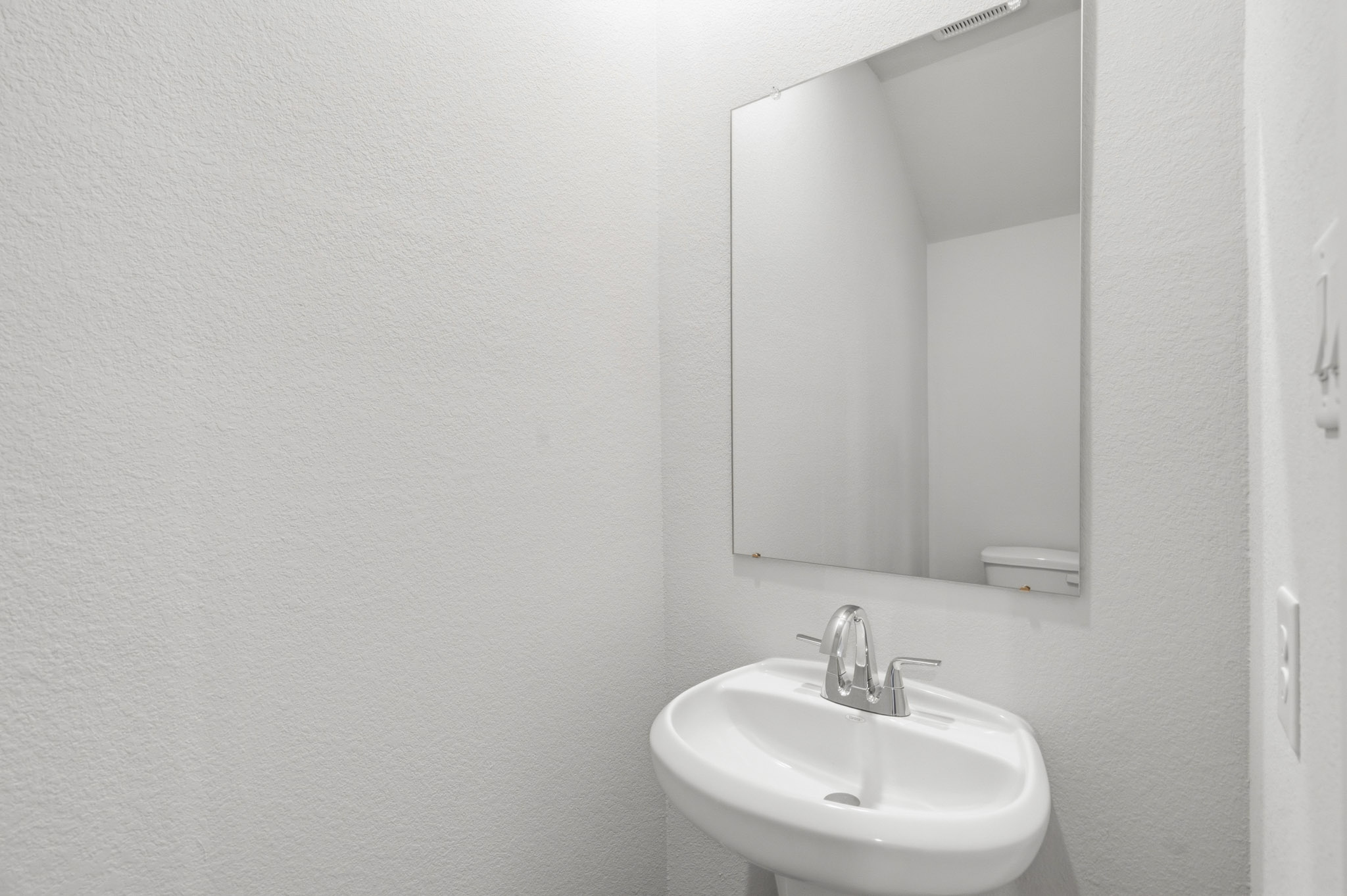 A bathroom with a large mirror.