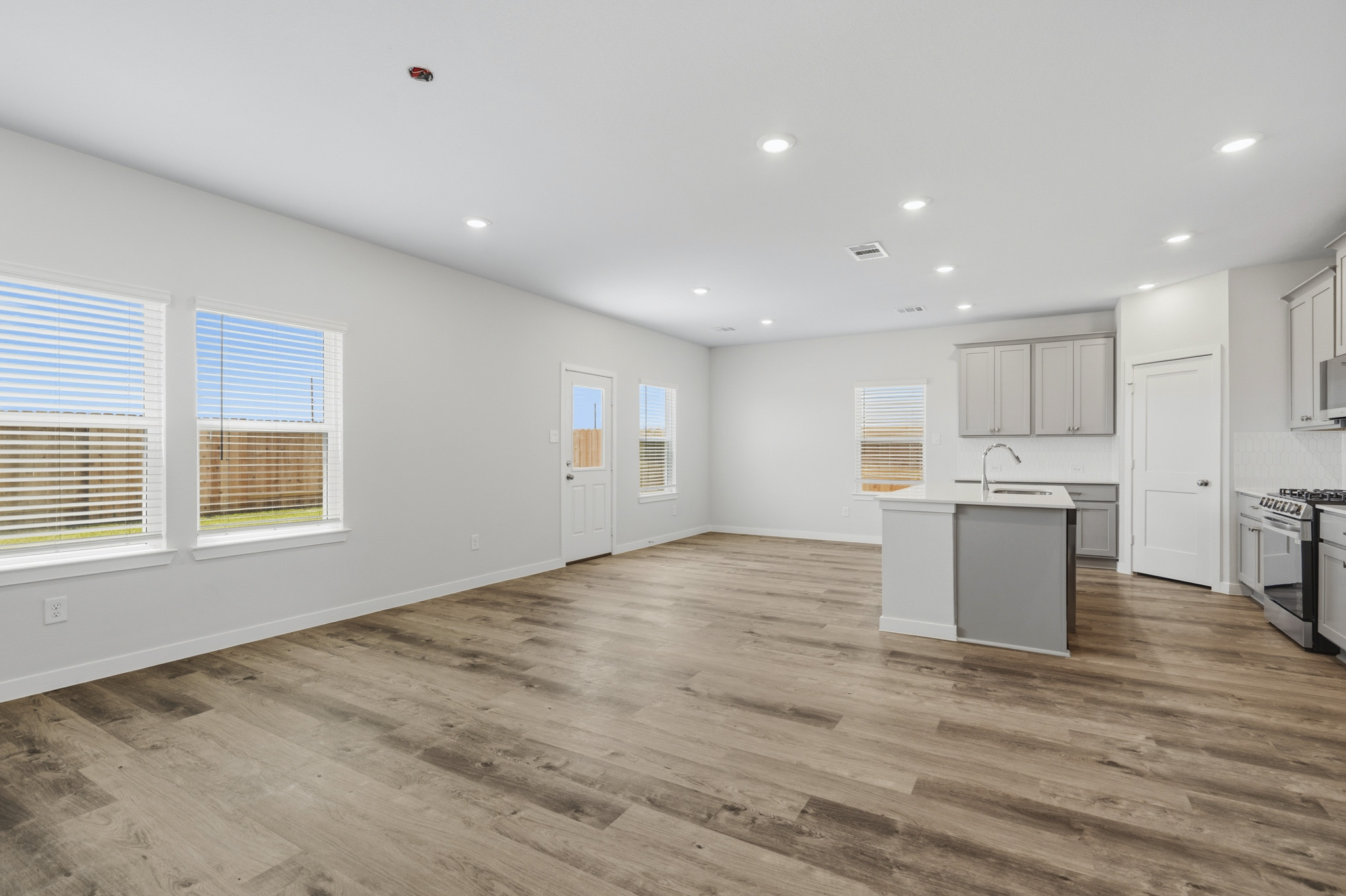 A kitchen with white cabinets.