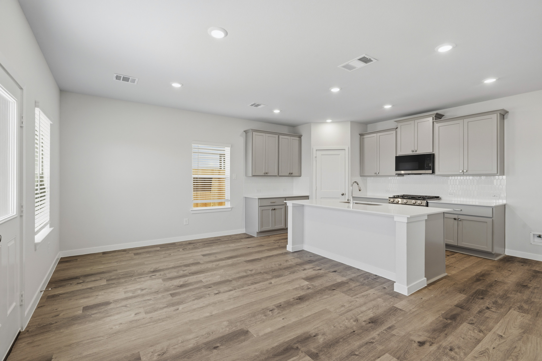 A kitchen with white cabinets.