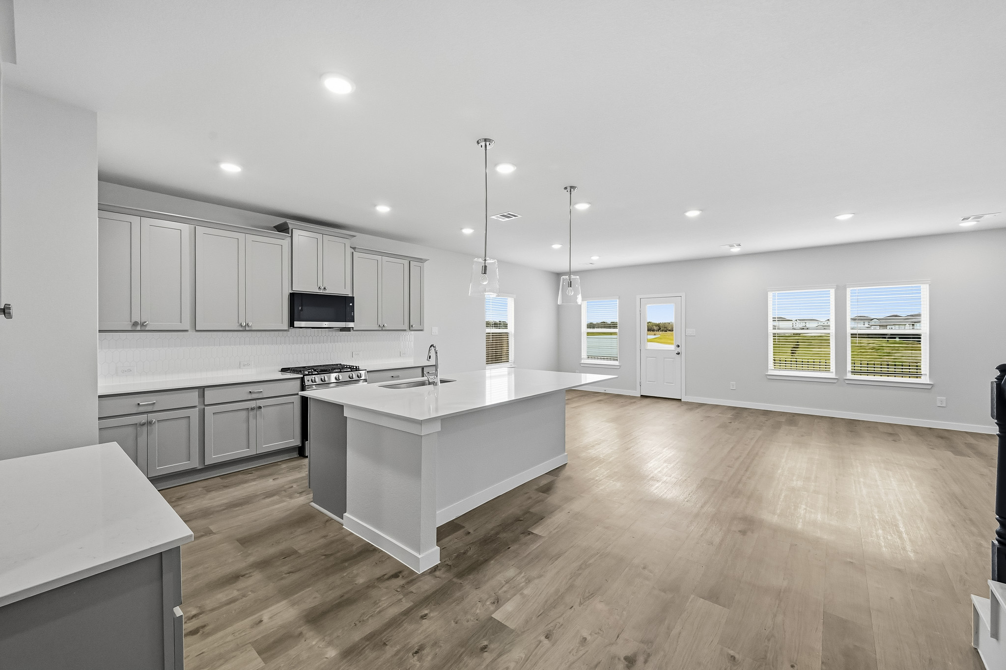 A kitchen with white cabinets.