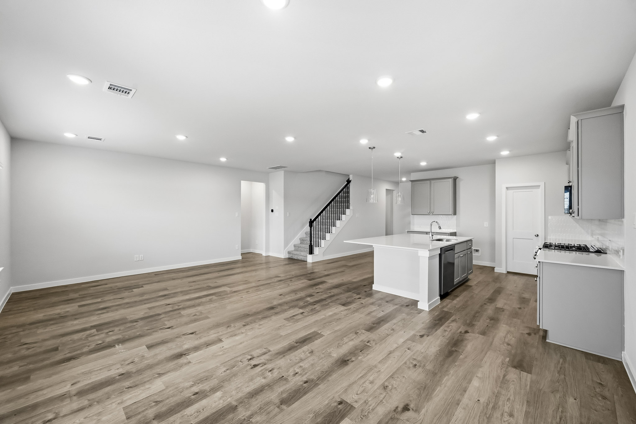 A large kitchen with wood floors.
