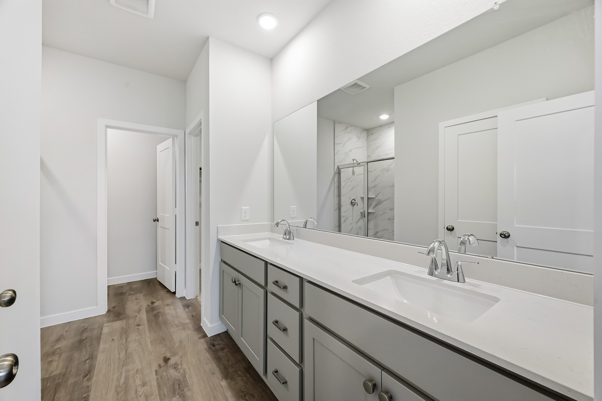 A bathroom with a large mirror.