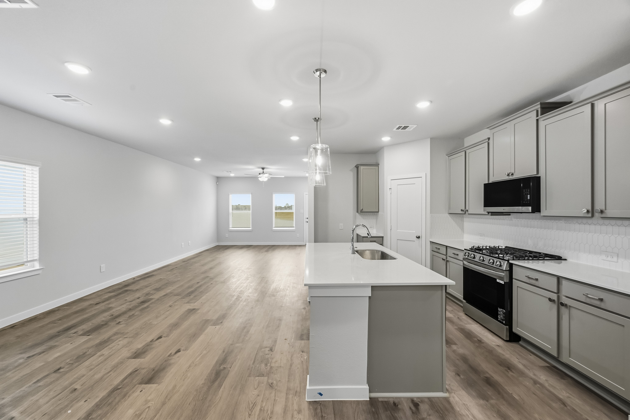 A kitchen with white cabinets.