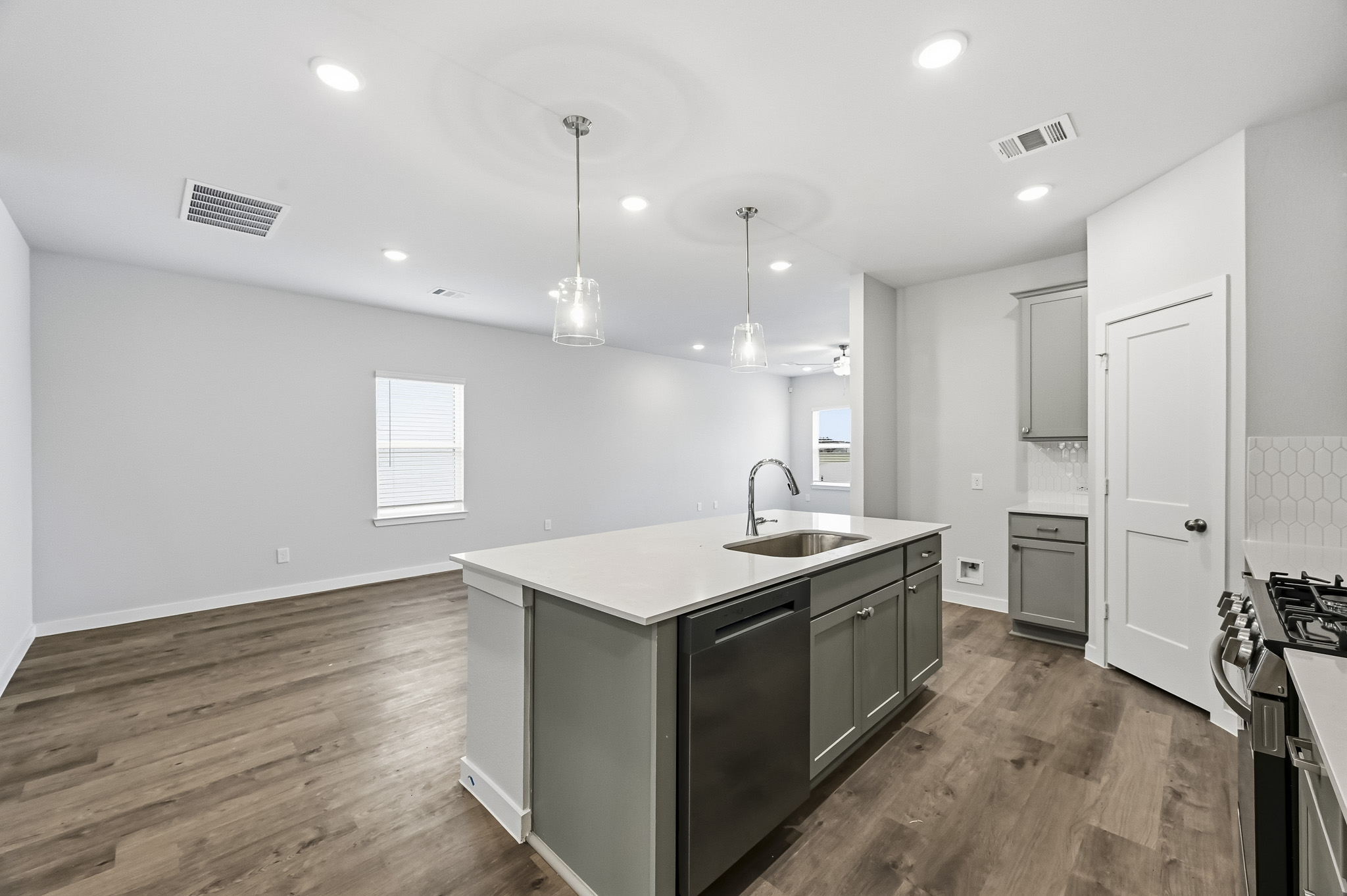 A kitchen with a wood floor.