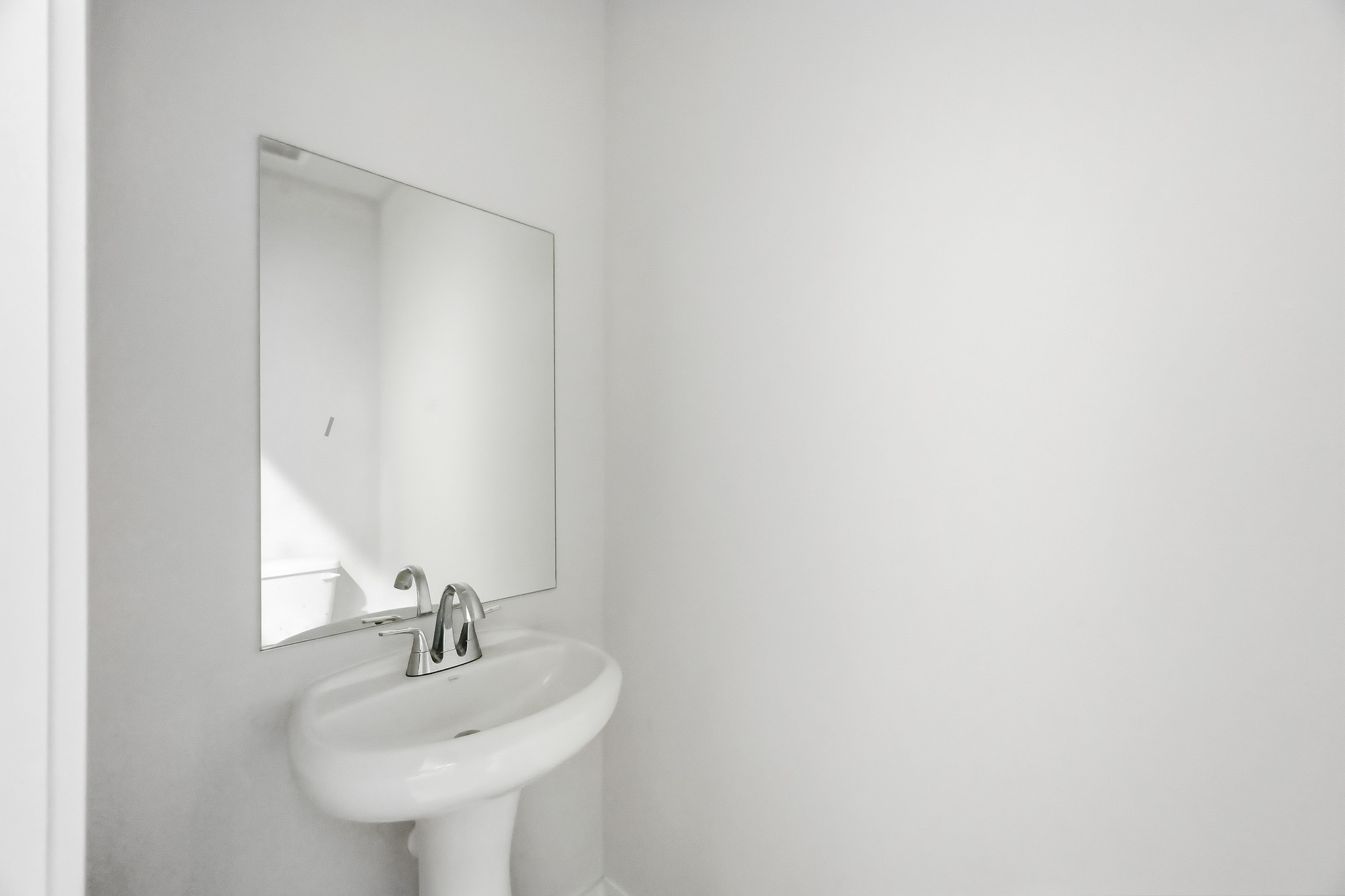 A bathroom with a mirror and sink.