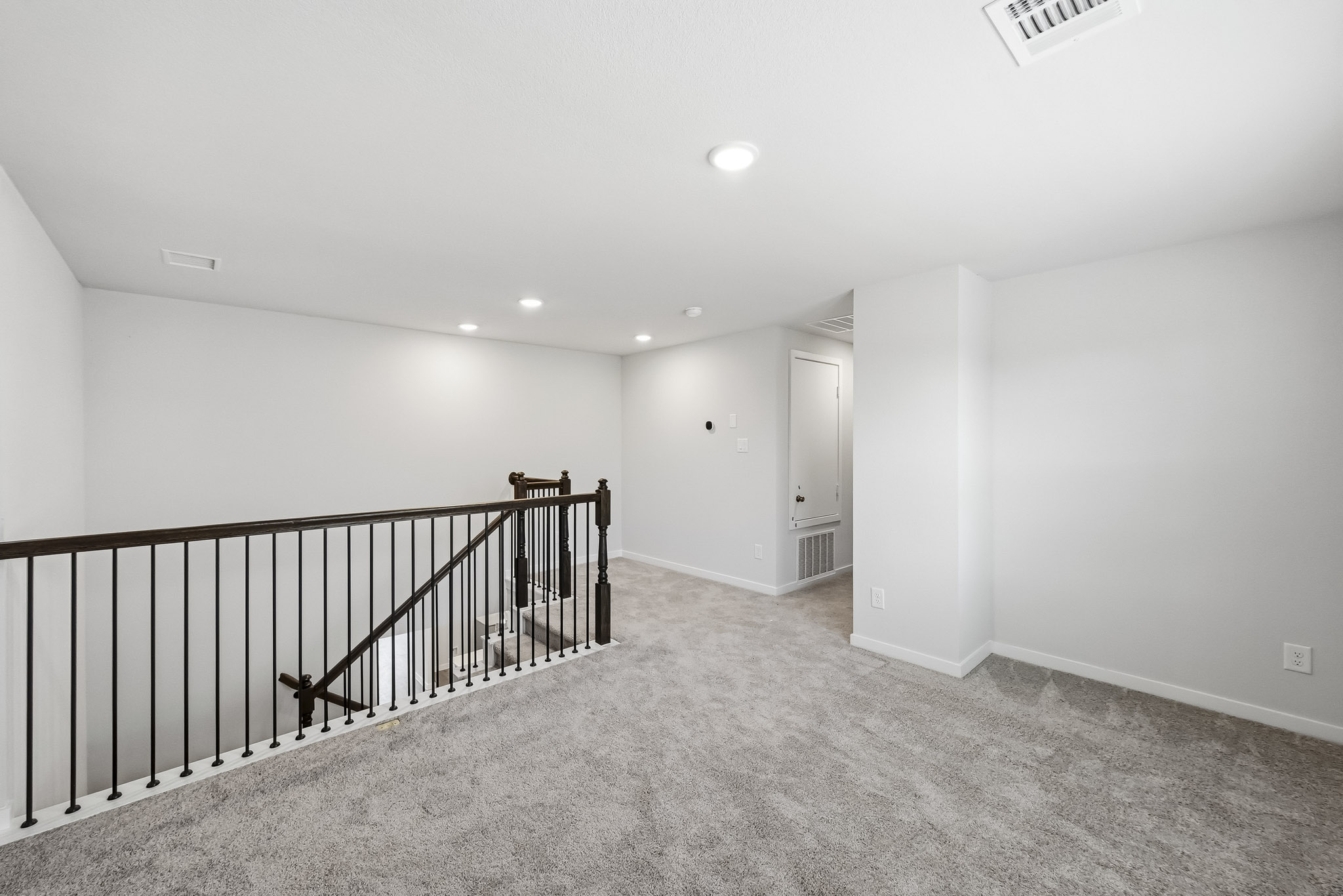 A hallway with a railing.