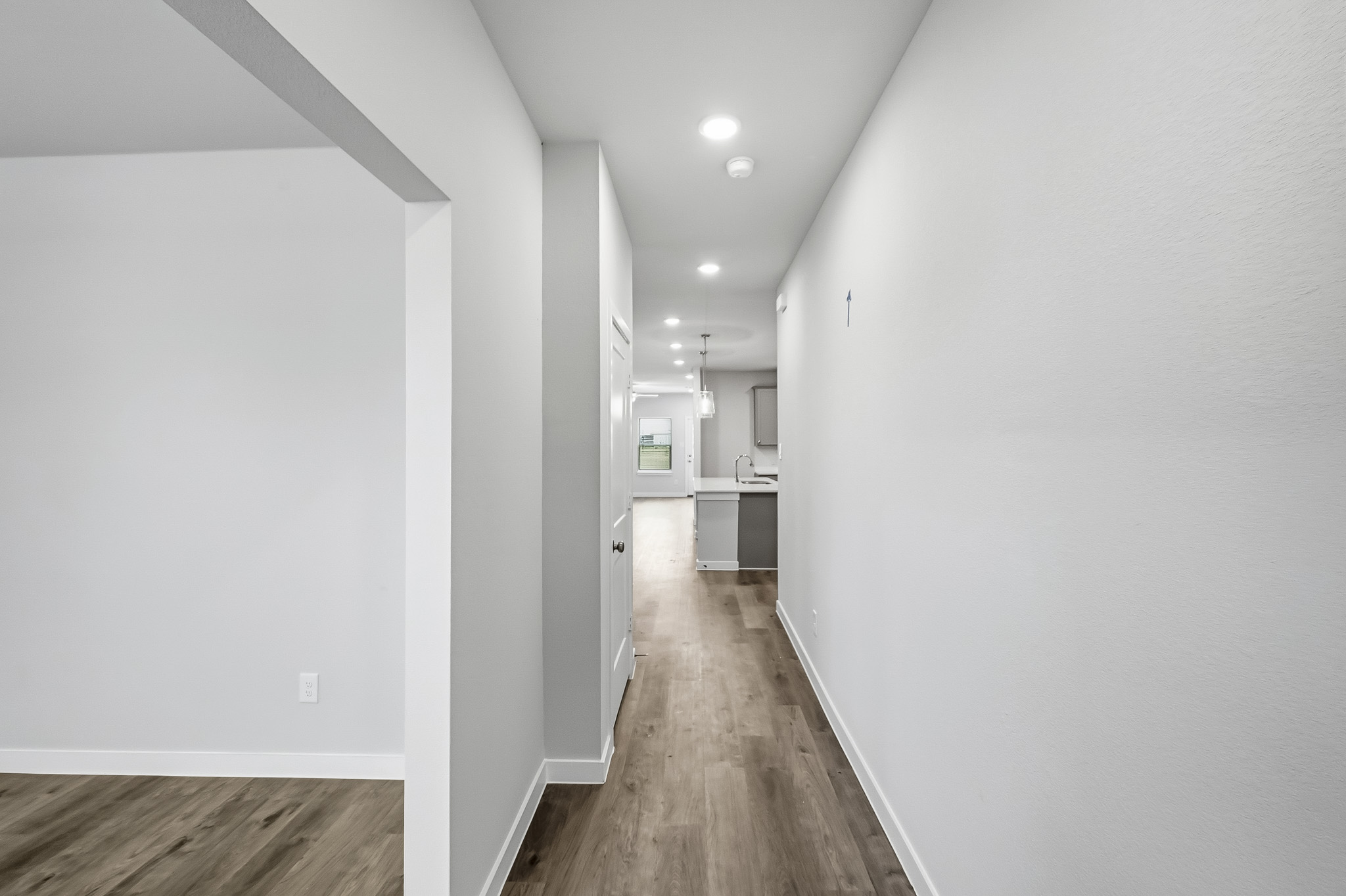 A hallway with white walls.