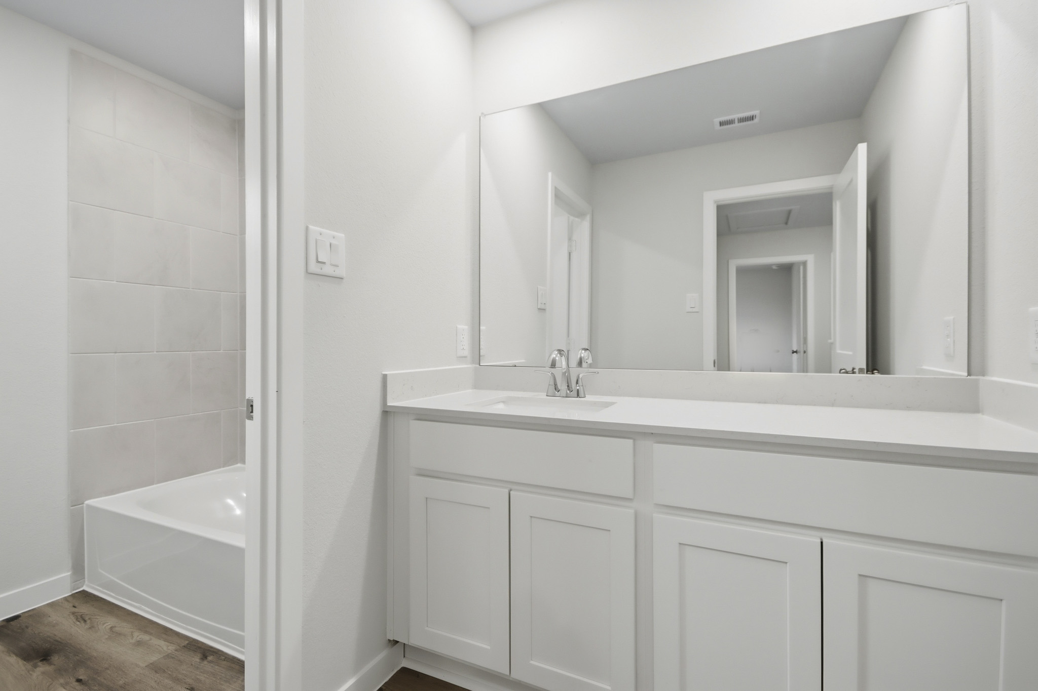 A bathroom with a sink and a tub.