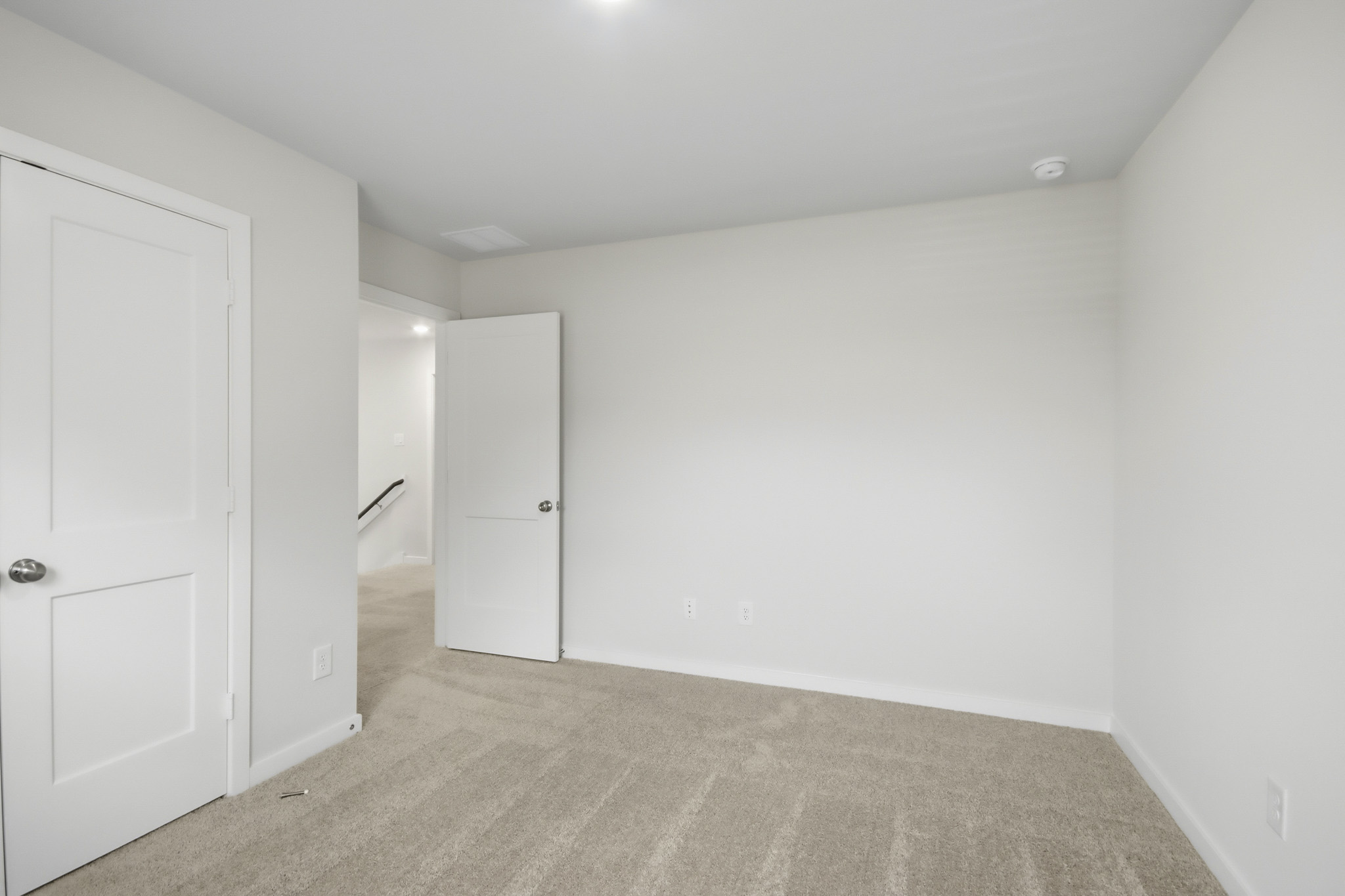 A hallway with white doors.