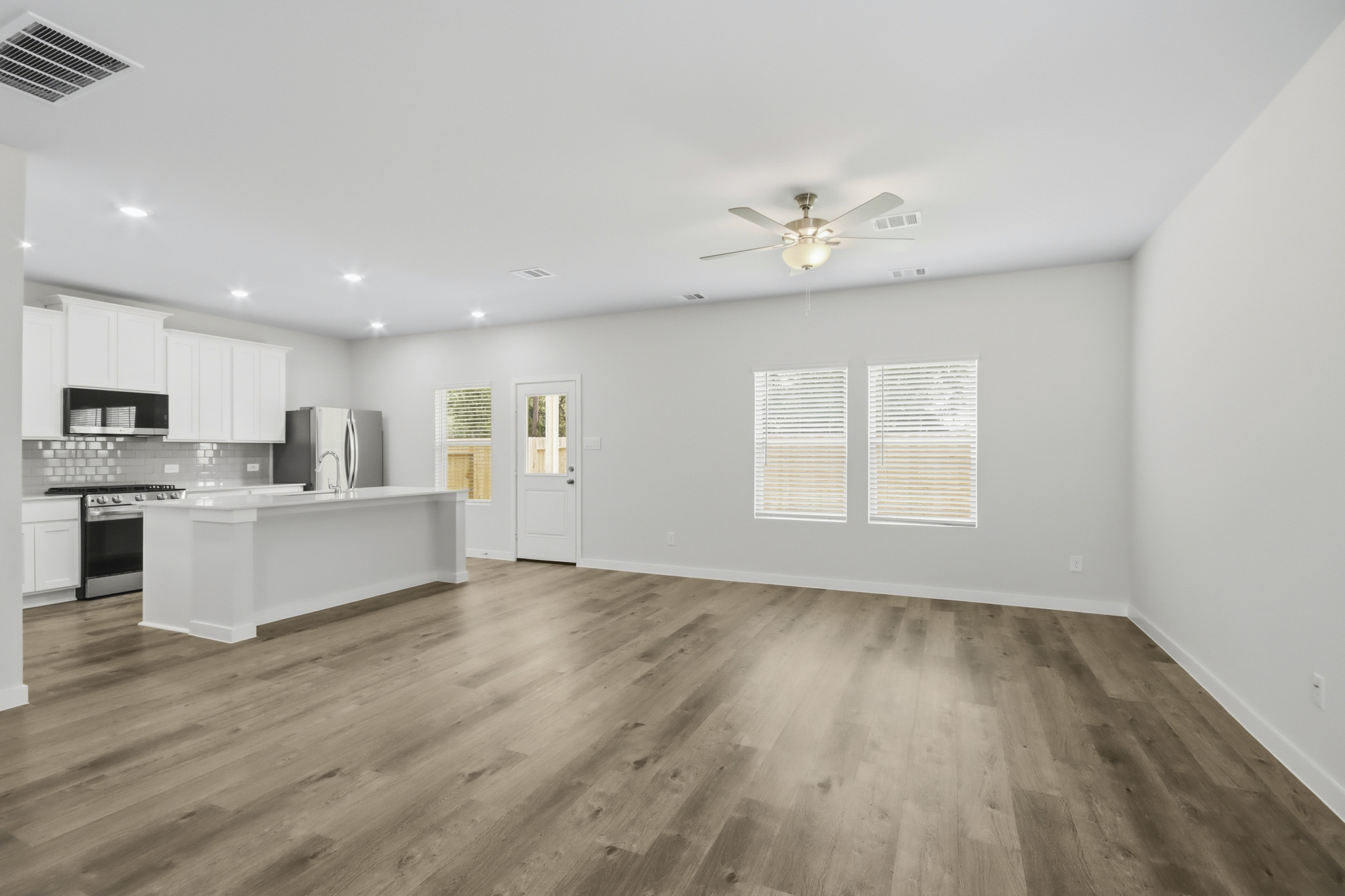 A kitchen with white cabinets.