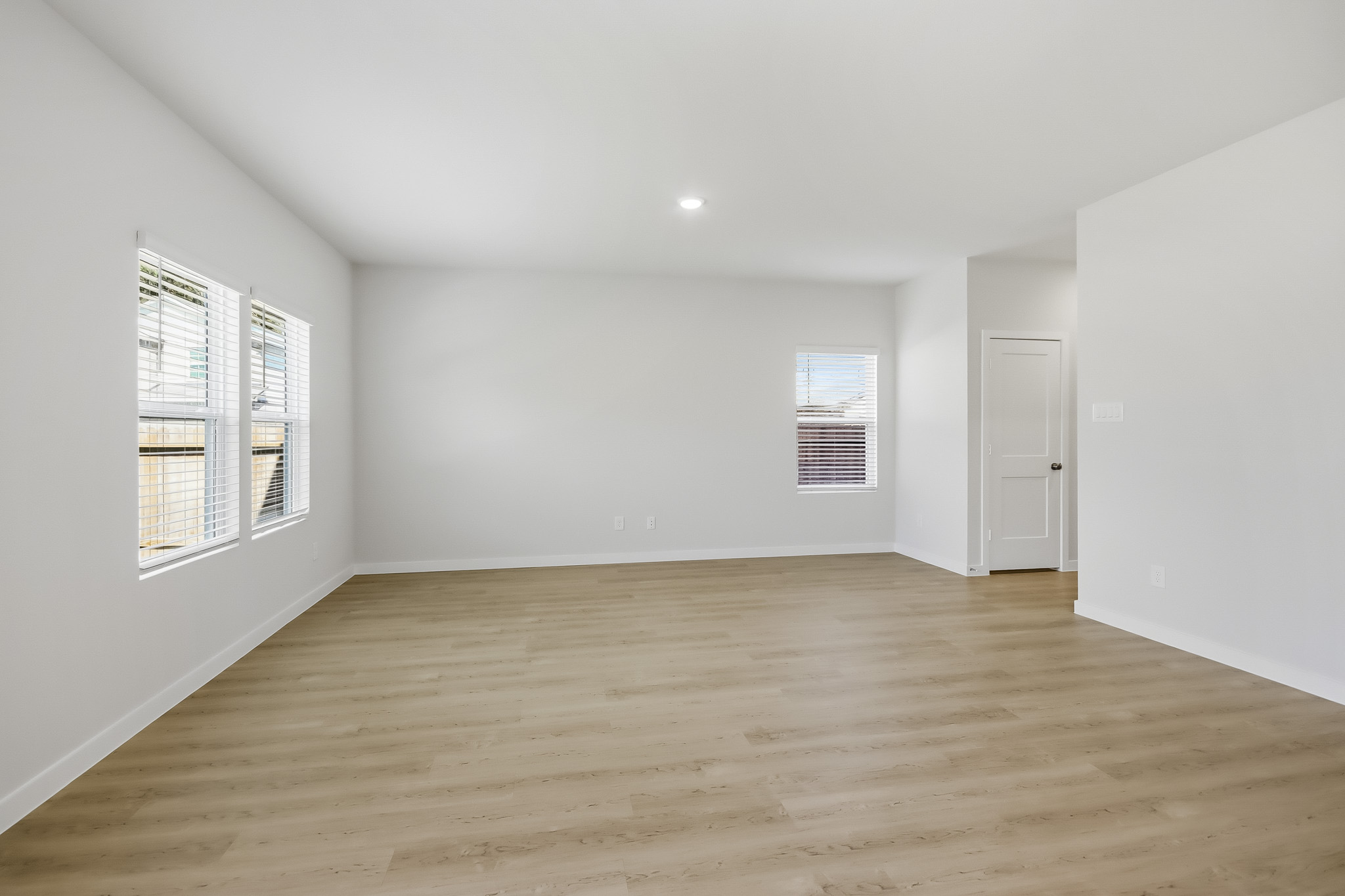 A room with a wood floor and white walls.