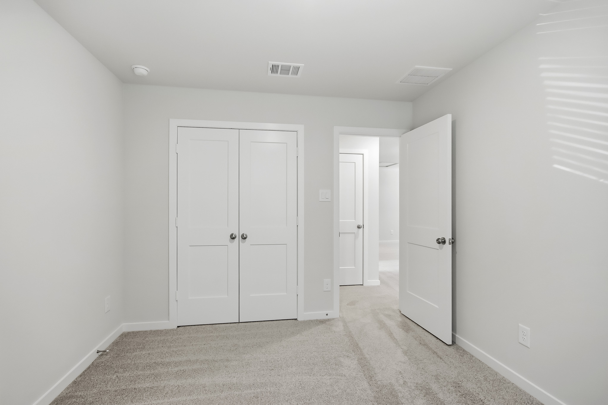 A hallway with white doors.
