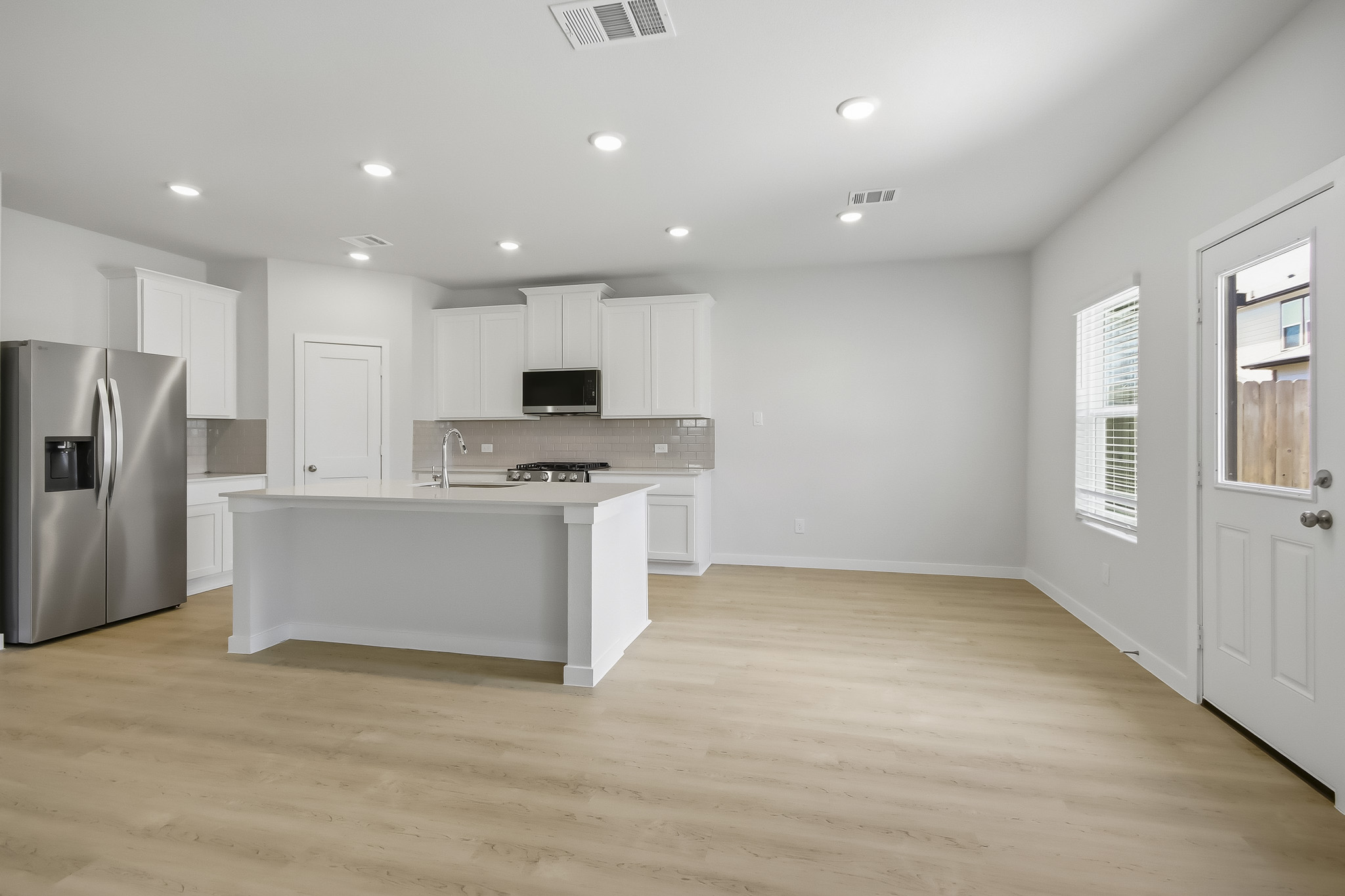 A kitchen with white cabinets.