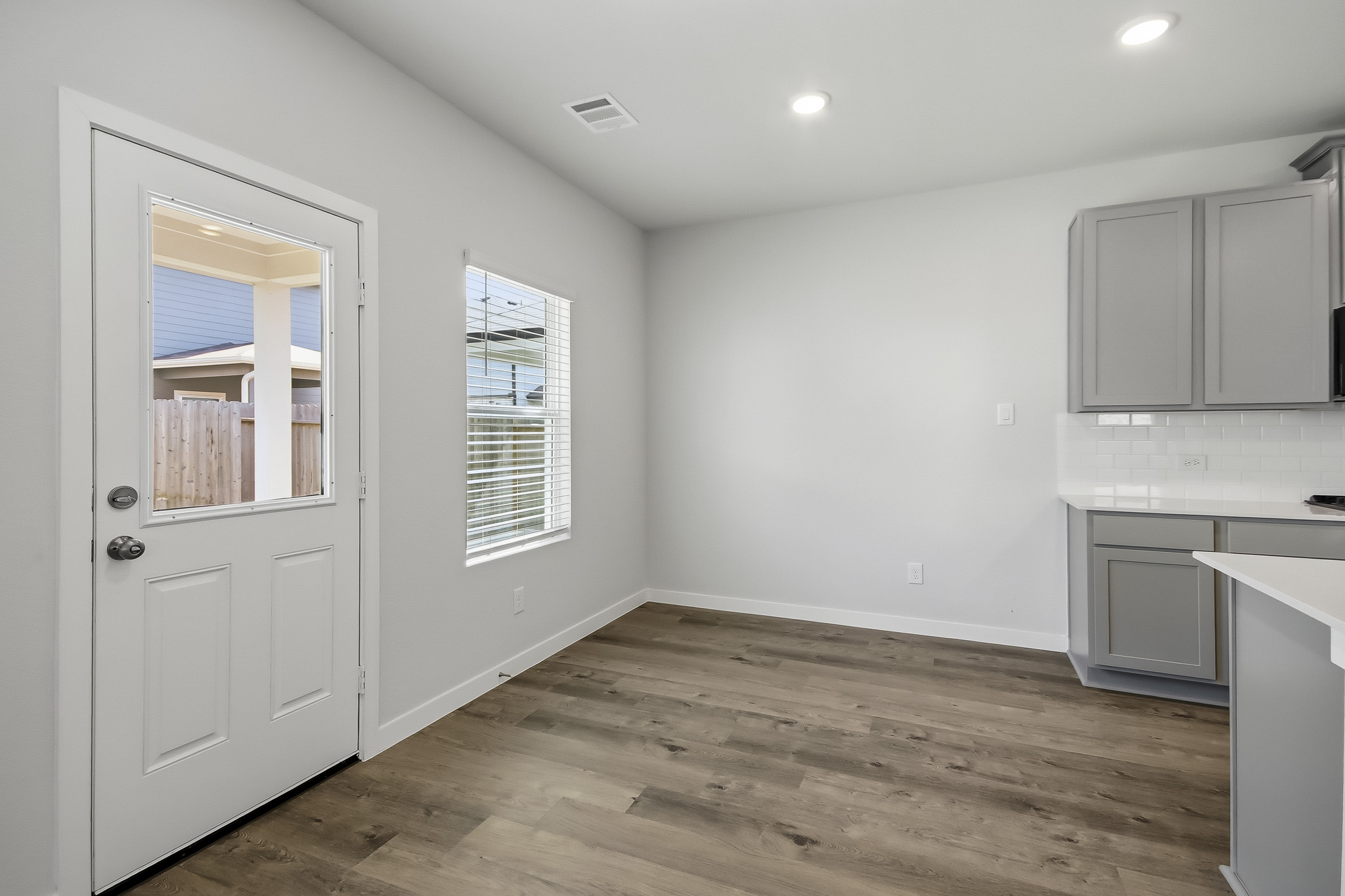 A room with white cabinets.