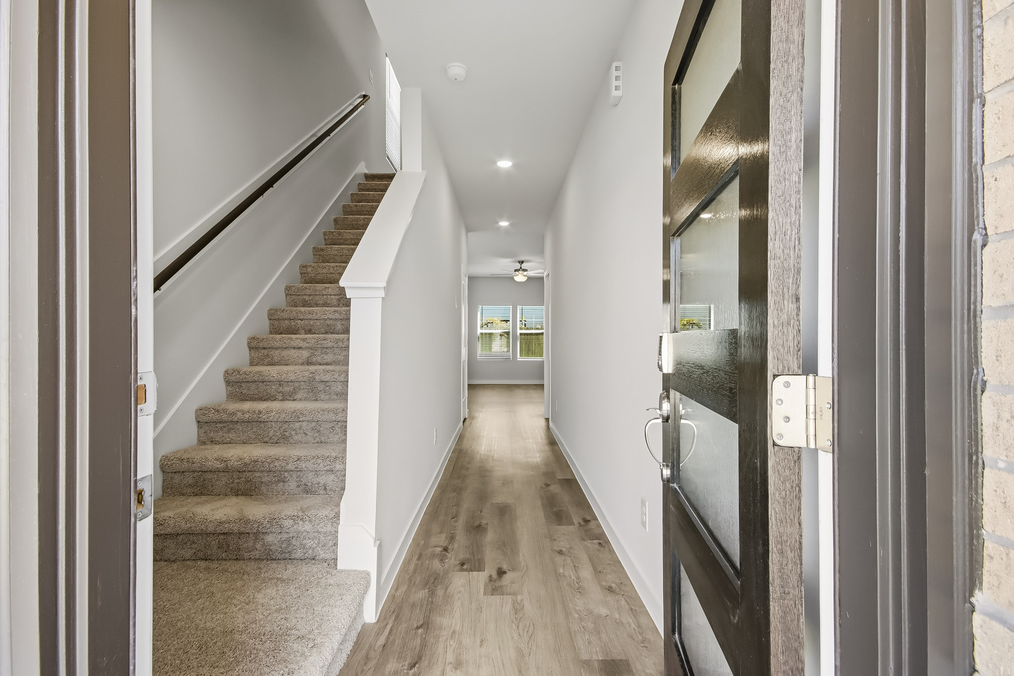 A long hallway with white walls.