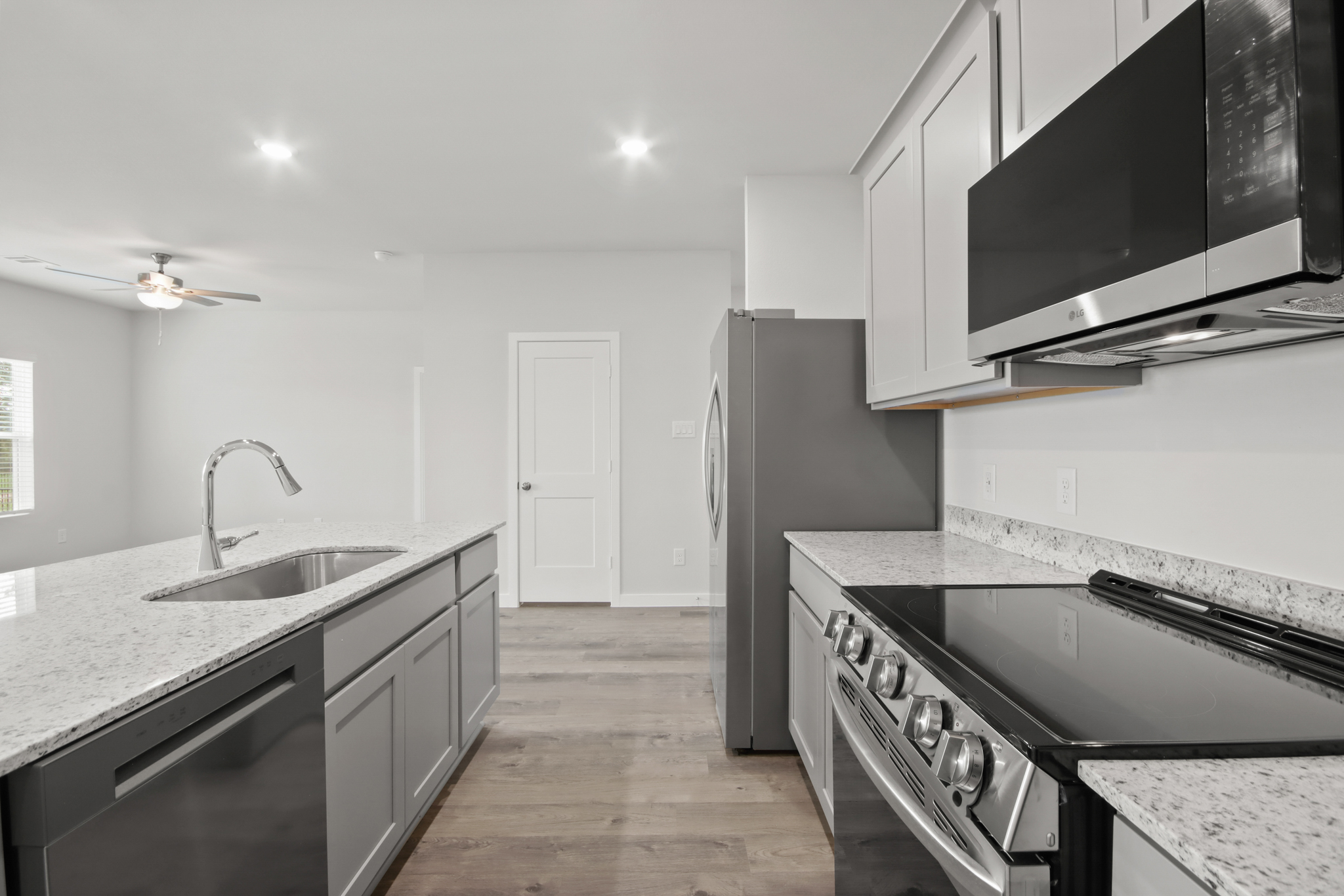 A kitchen with a stainless steel refrigerator.