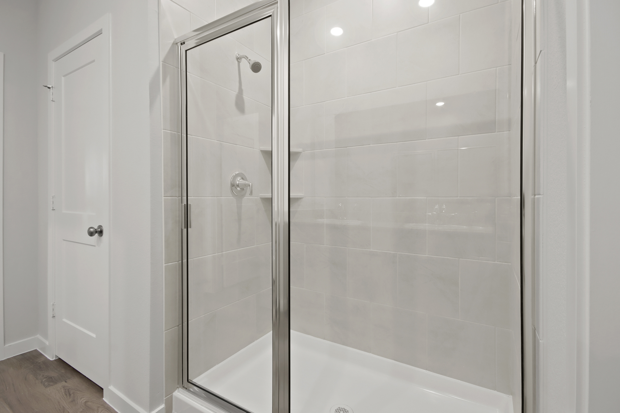 A shower with a glass door.