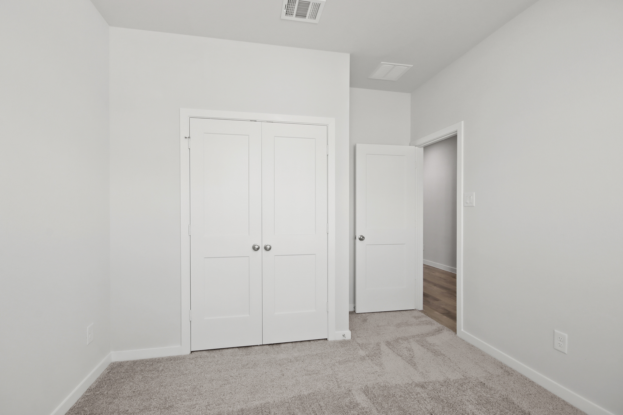 A hallway with white doors.