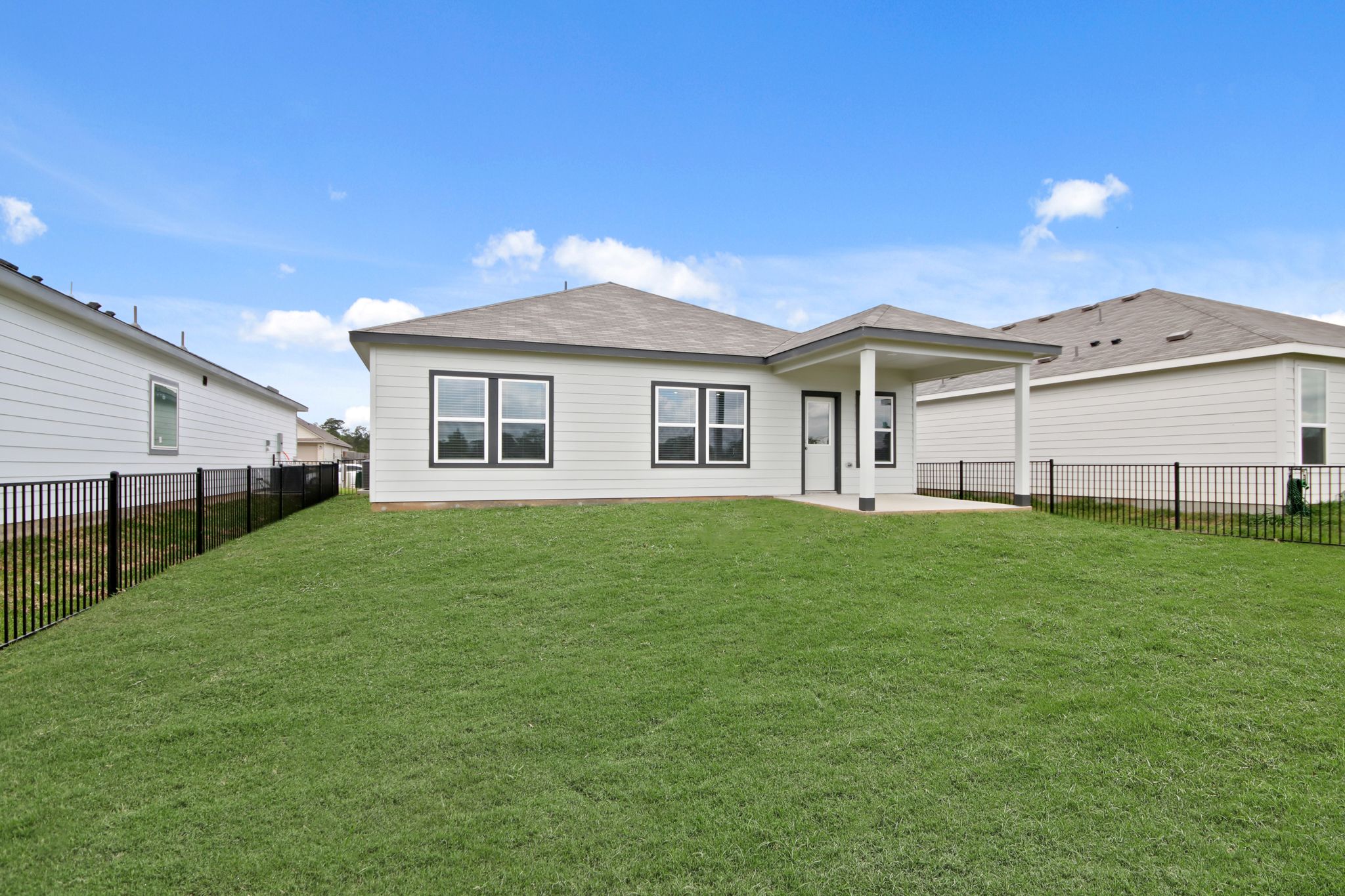 A house with a fence and grass.