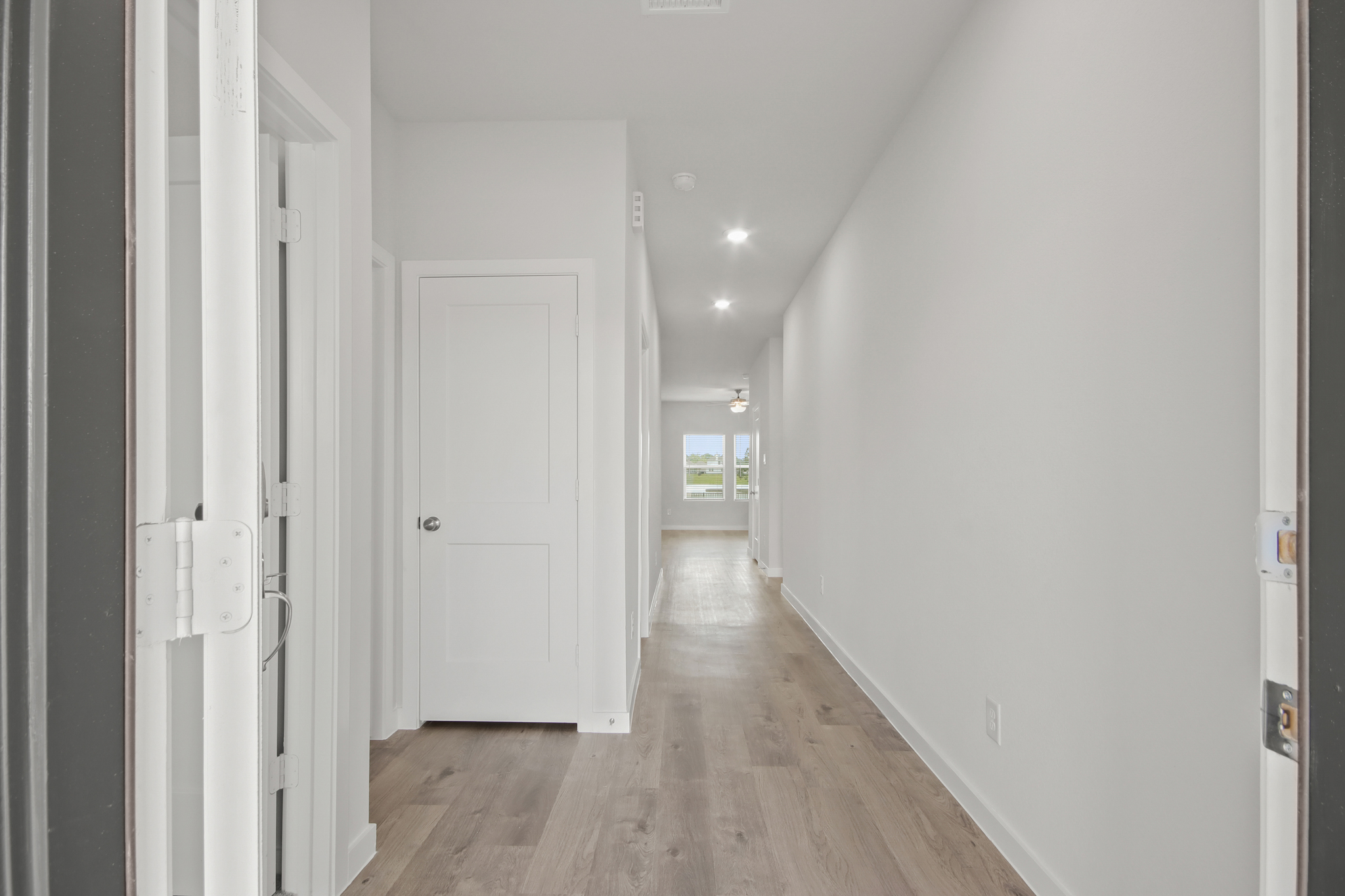 A hallway with white doors.