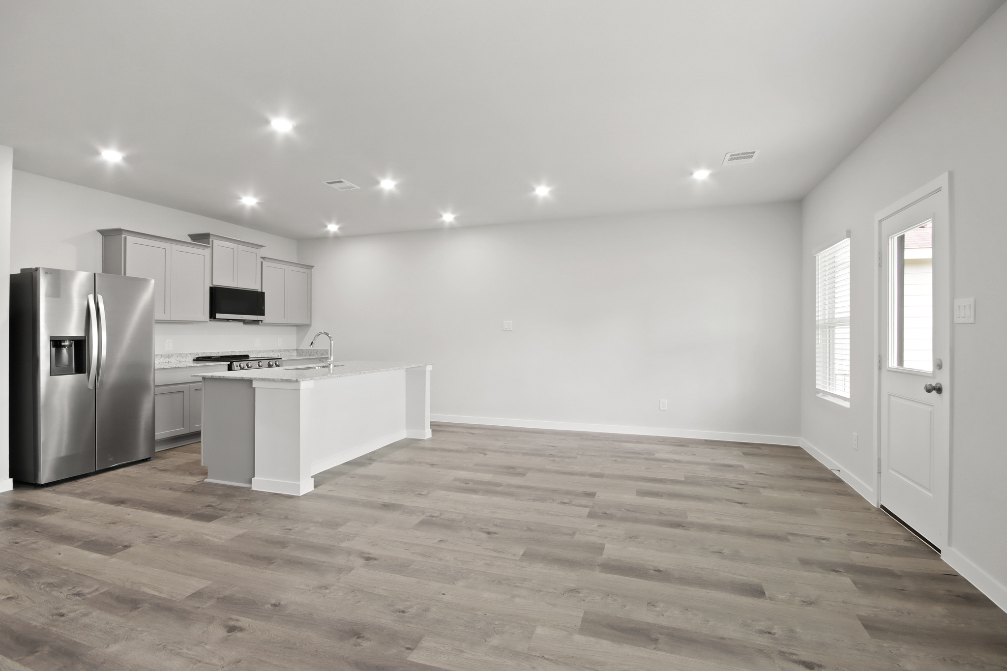 A kitchen with white cabinets.