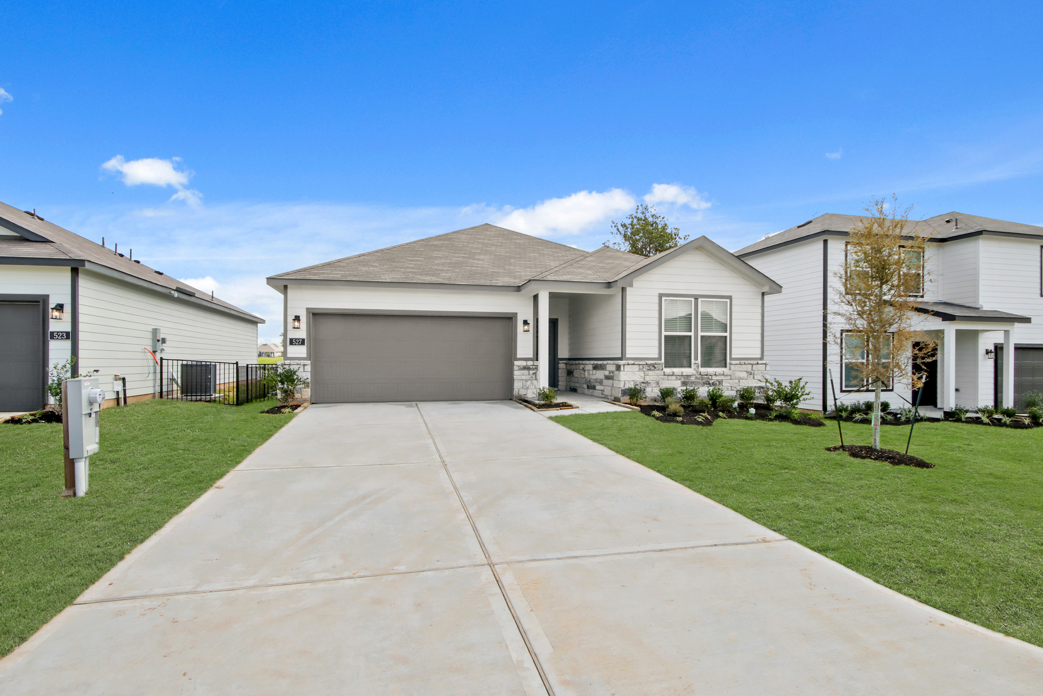 A driveway leading to a house.