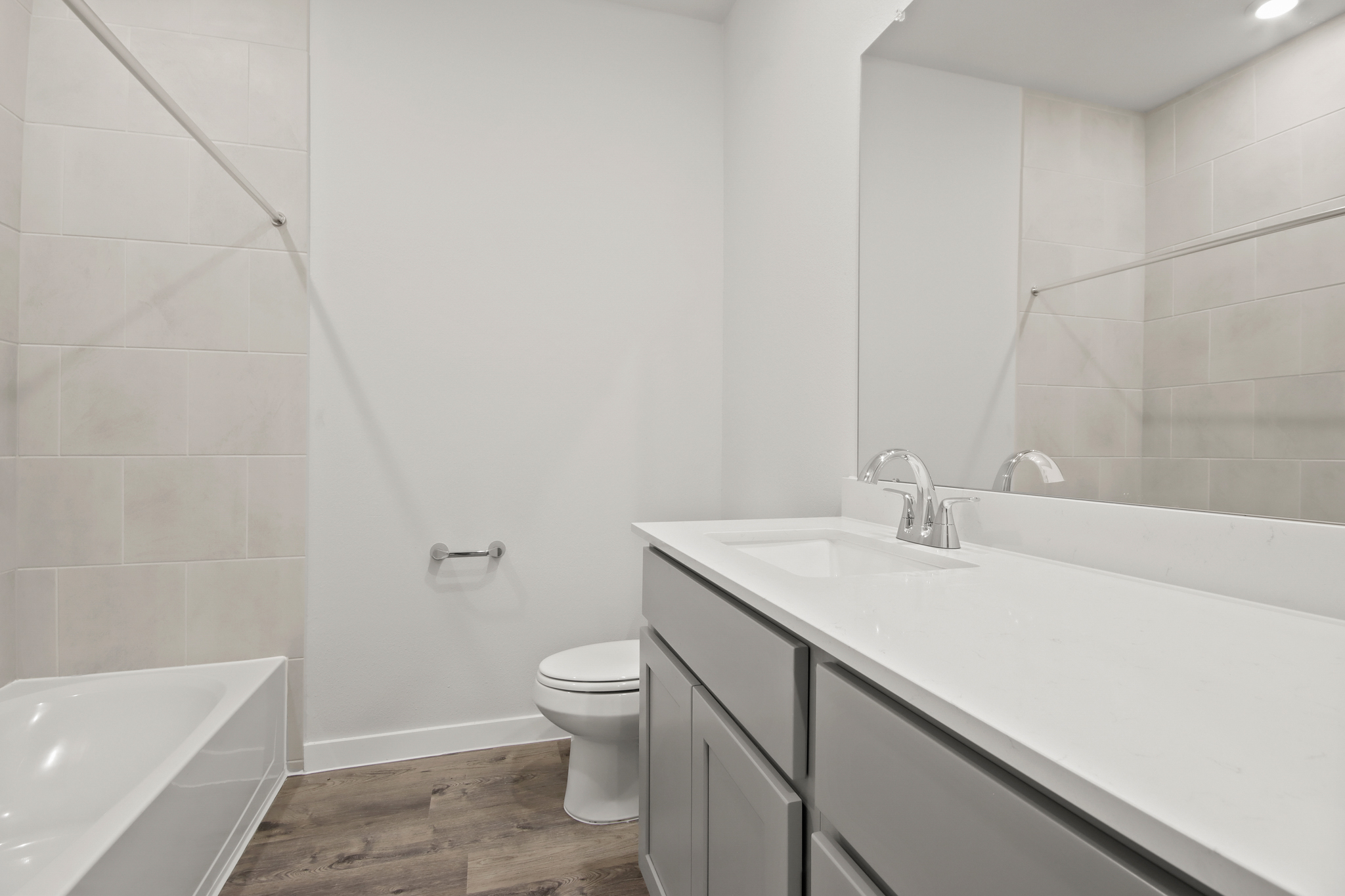 A bathroom with a tub sink and toilet.