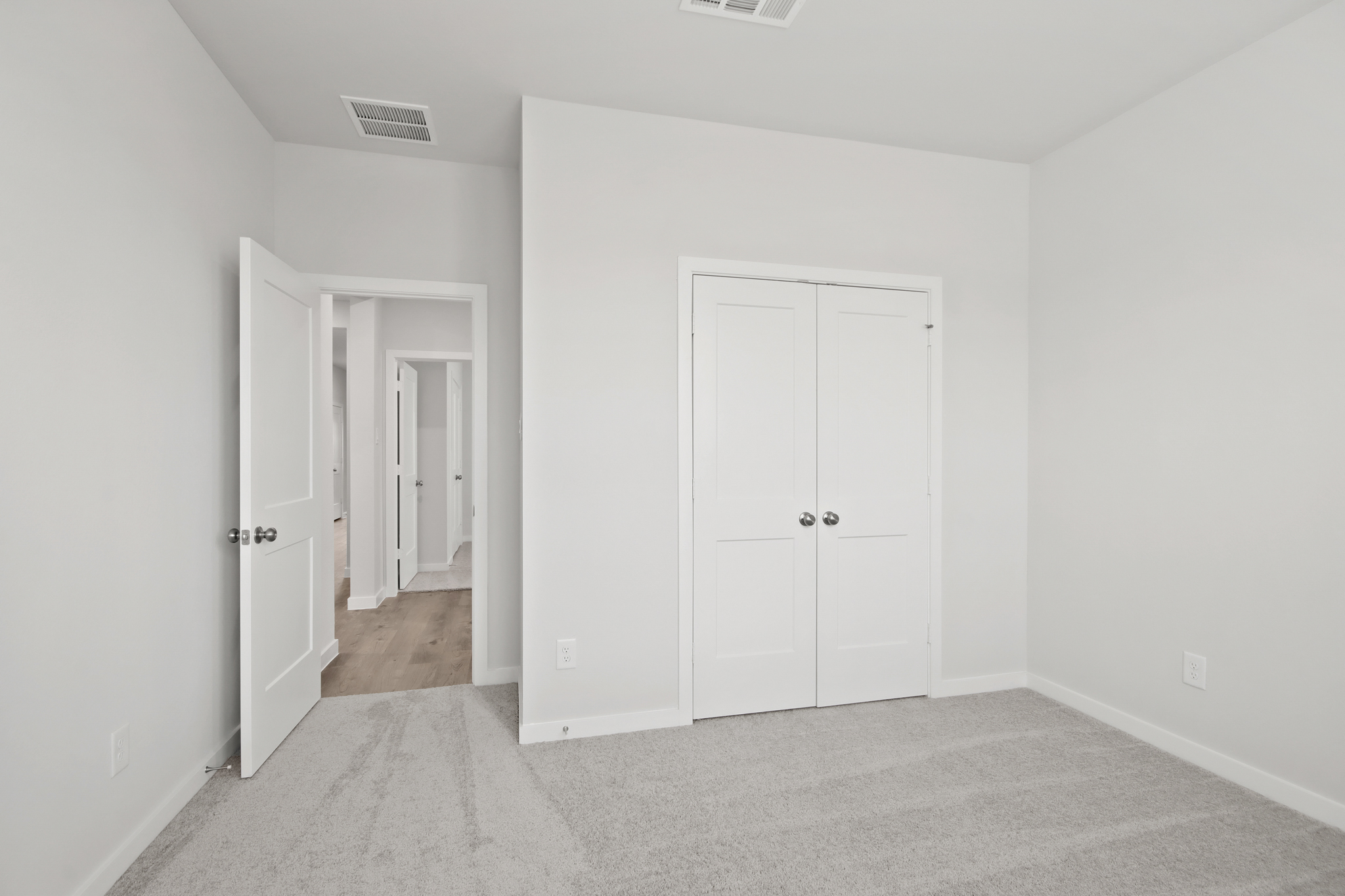 A hallway with white doors.