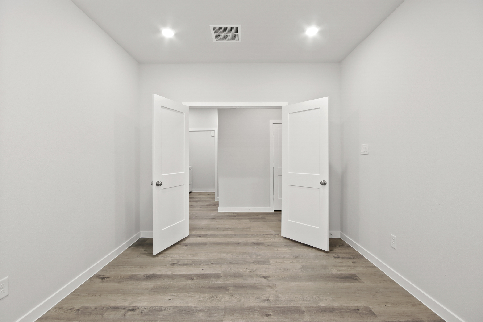 A room with white cabinets.