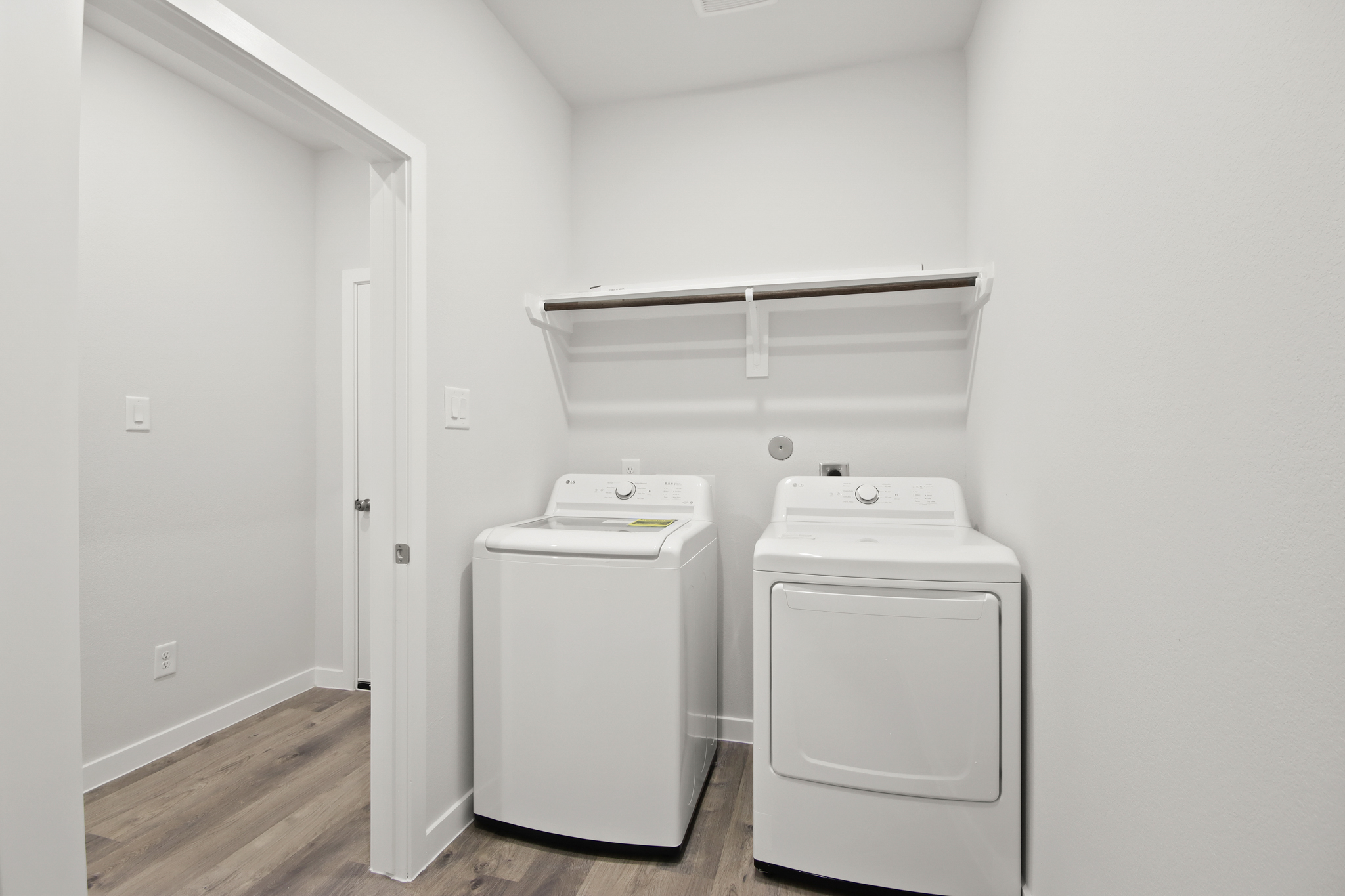 A room with a washer and dryer.