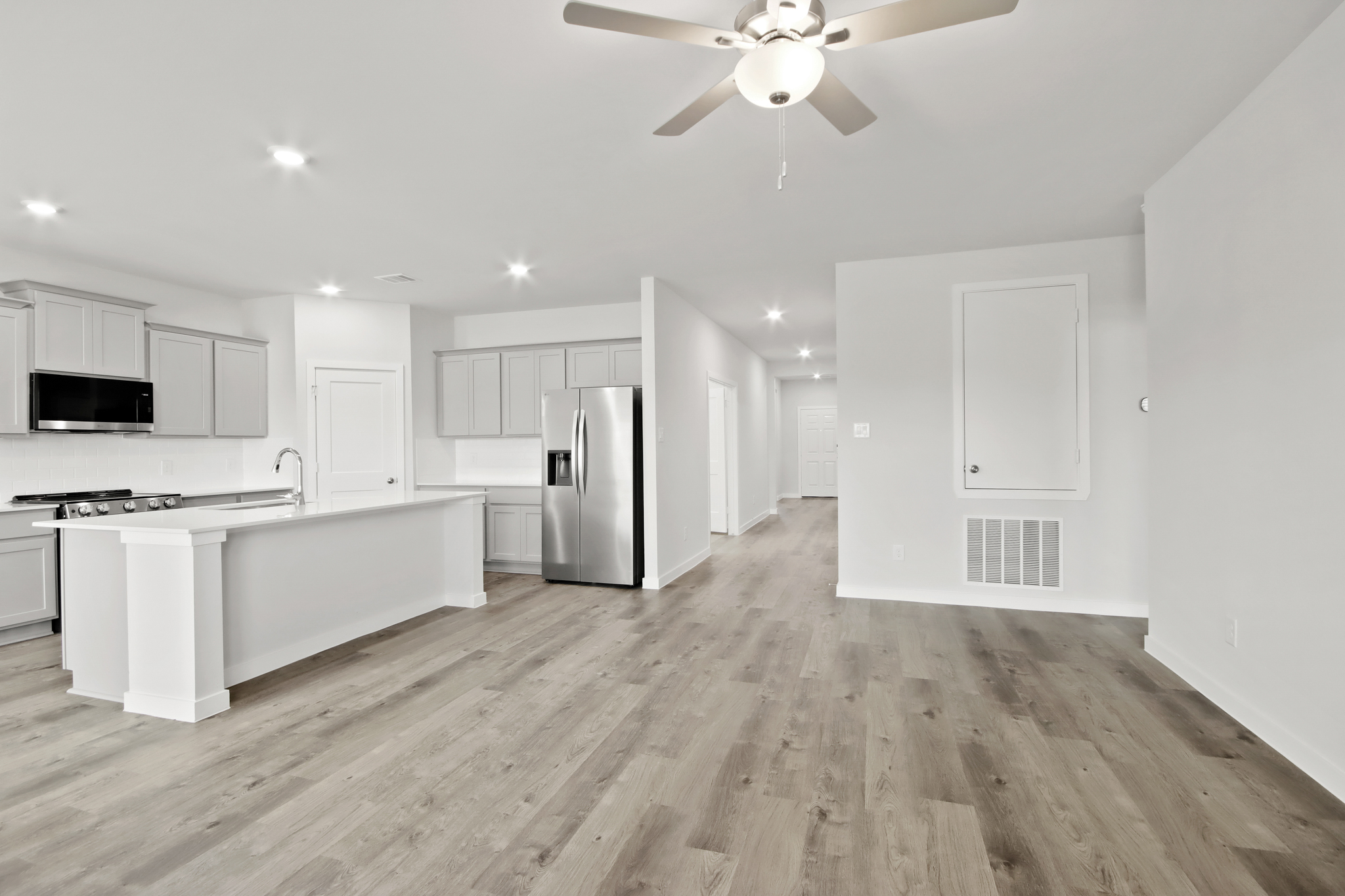 A kitchen with white cabinets.