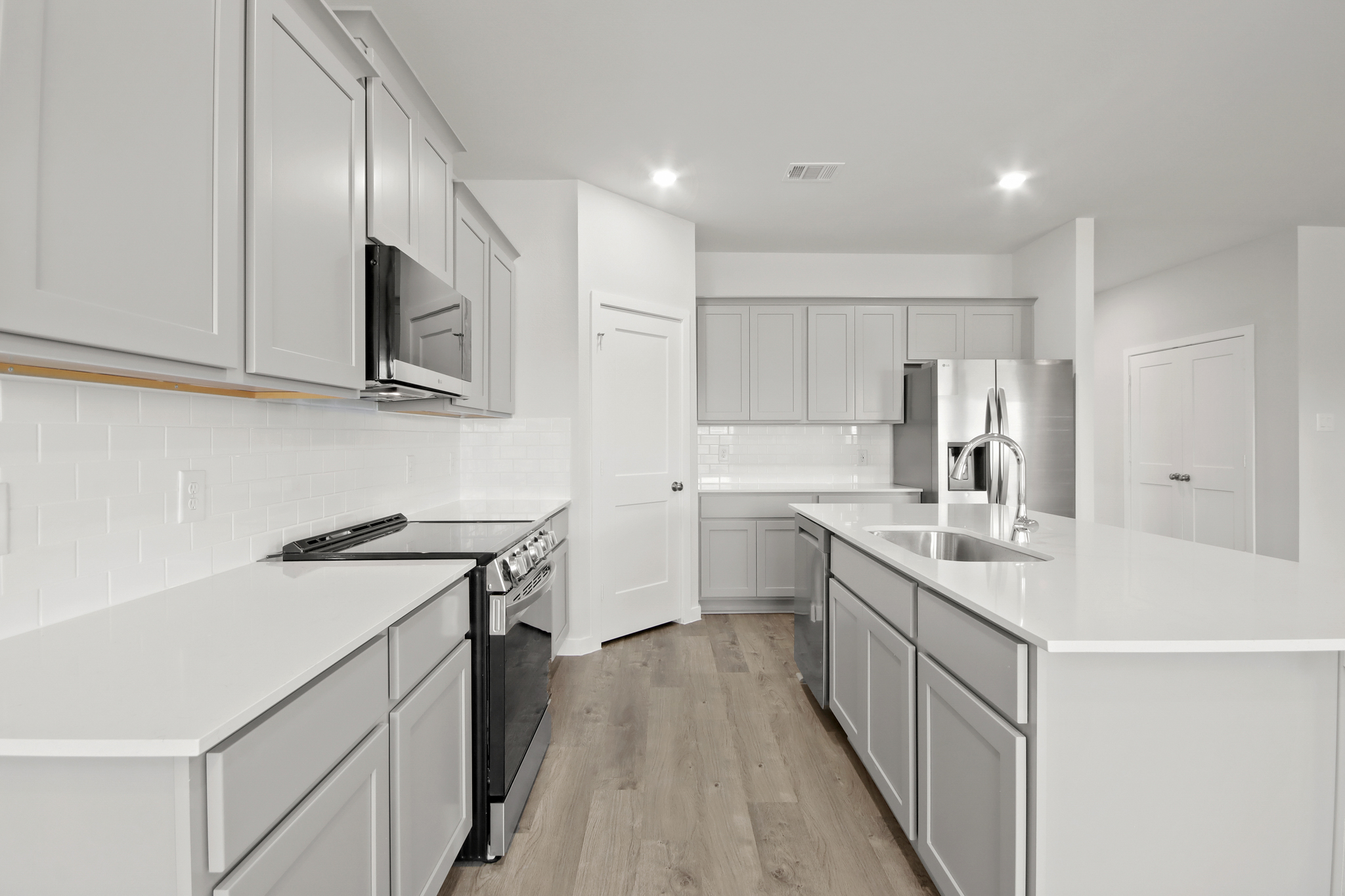 A kitchen with white cabinets.