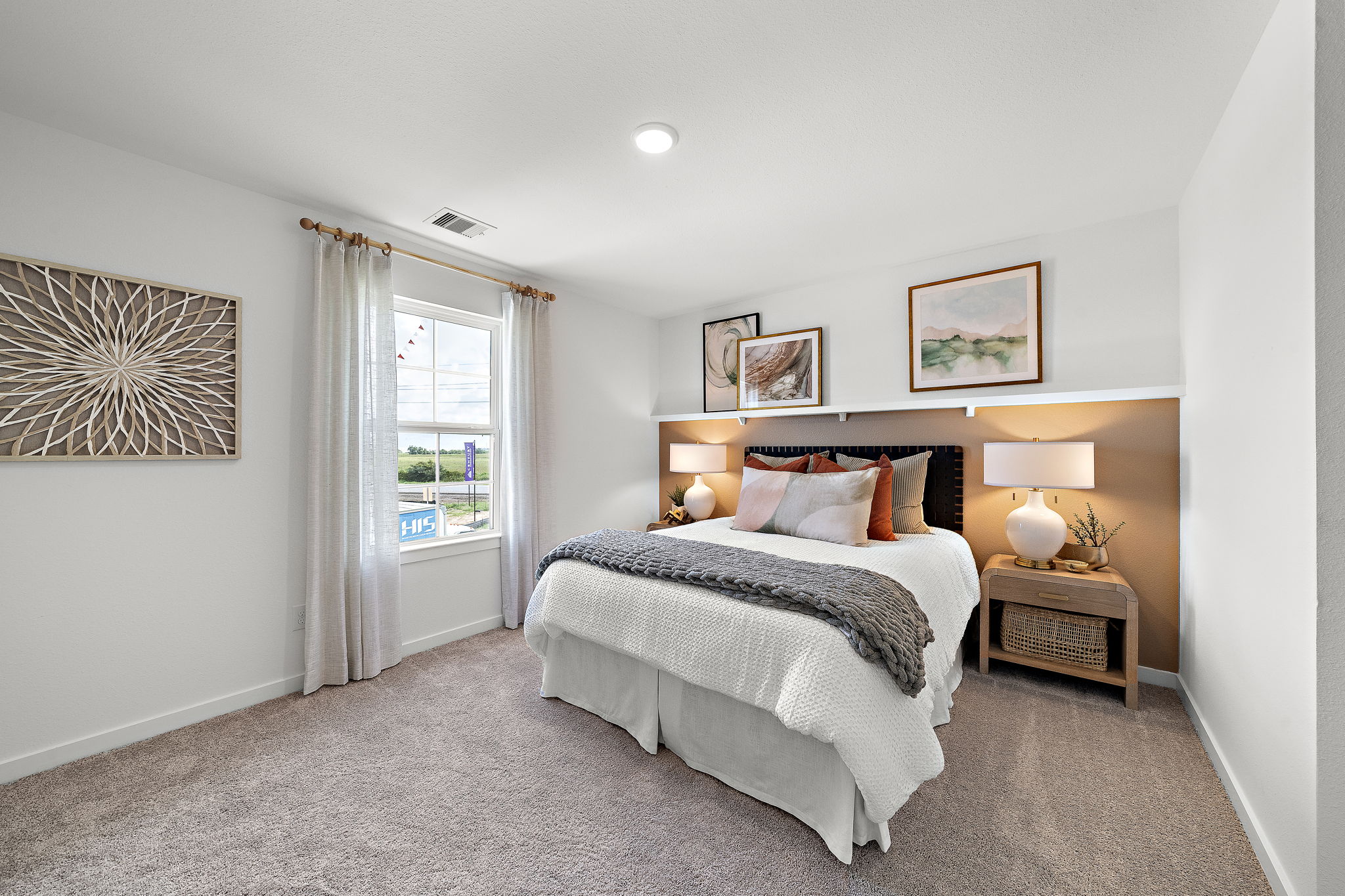 A bedroom with a bed and lamps.