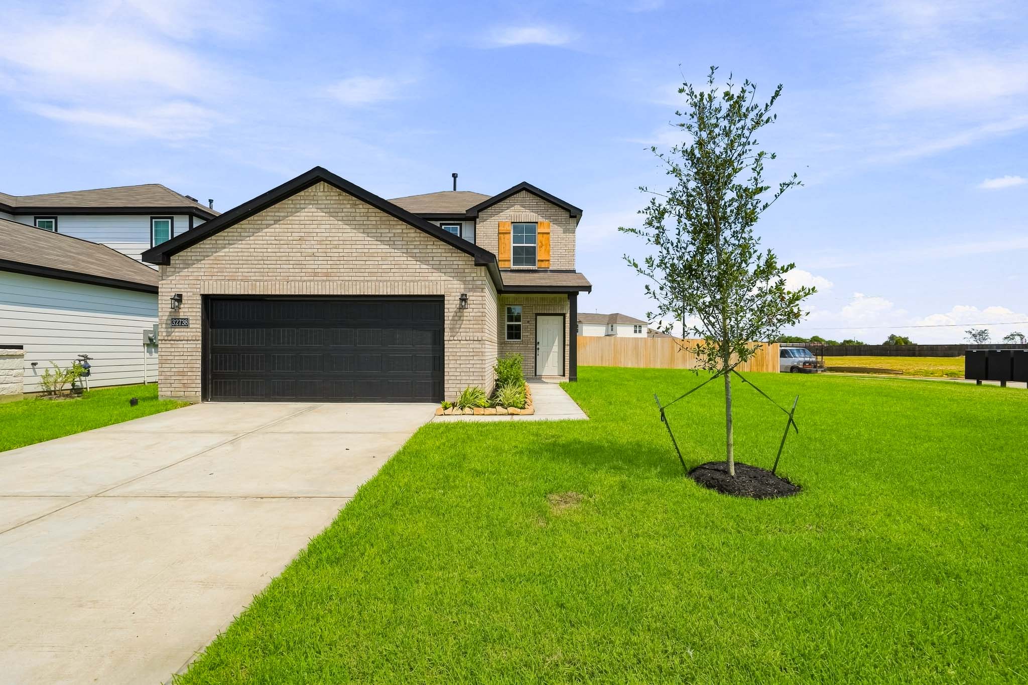 A house with a tree in the front yard.