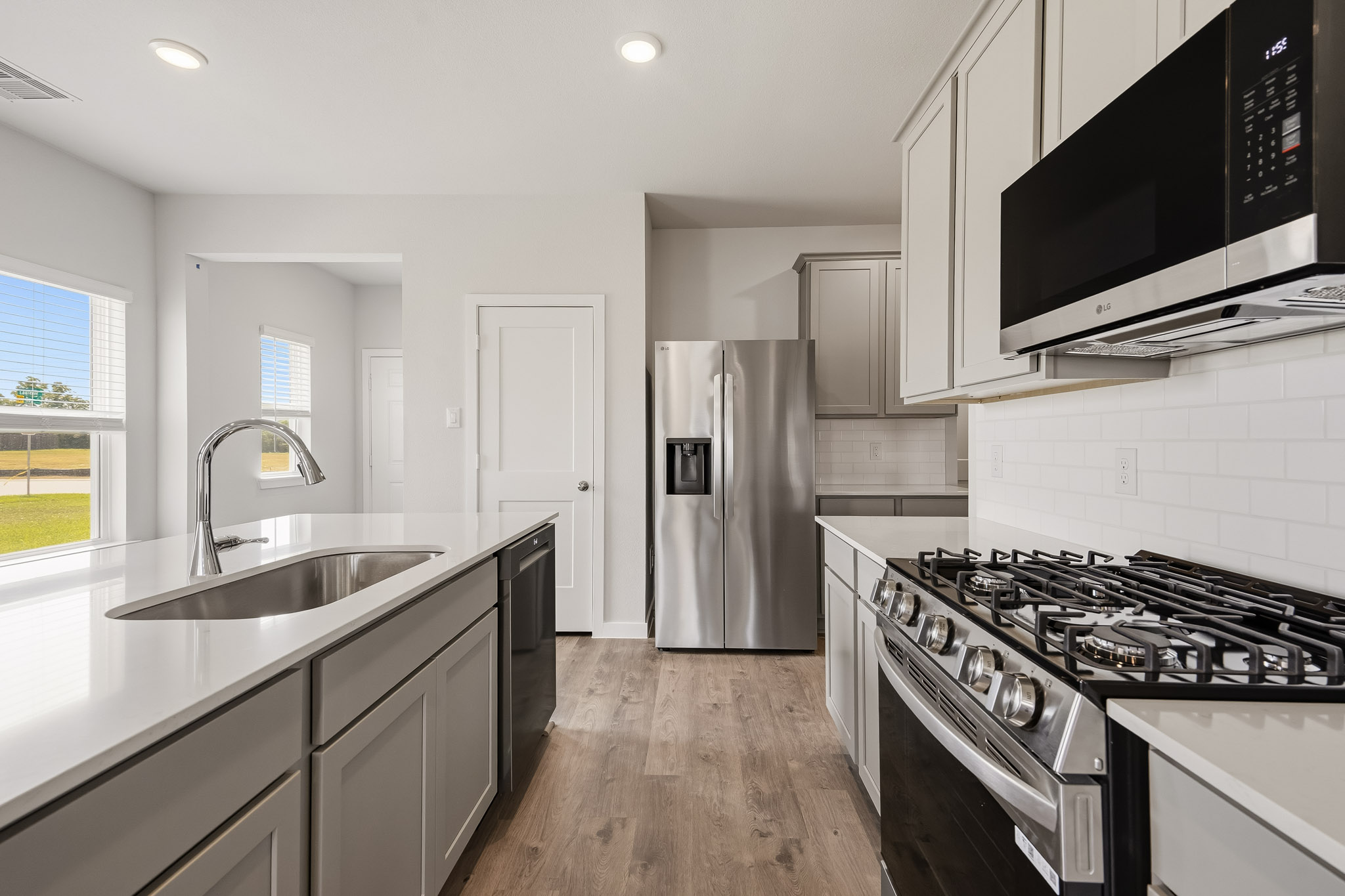 A kitchen with white cabinets.