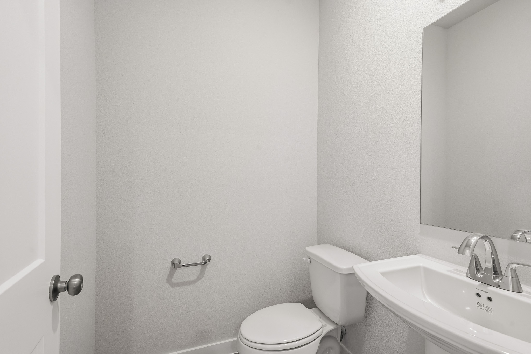 A bathroom with a toilet and sink.