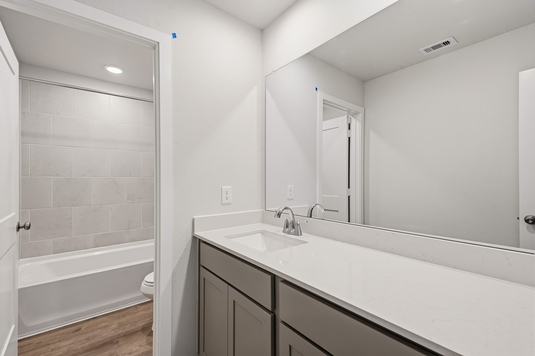 A bathroom with a tub sink and a shower.