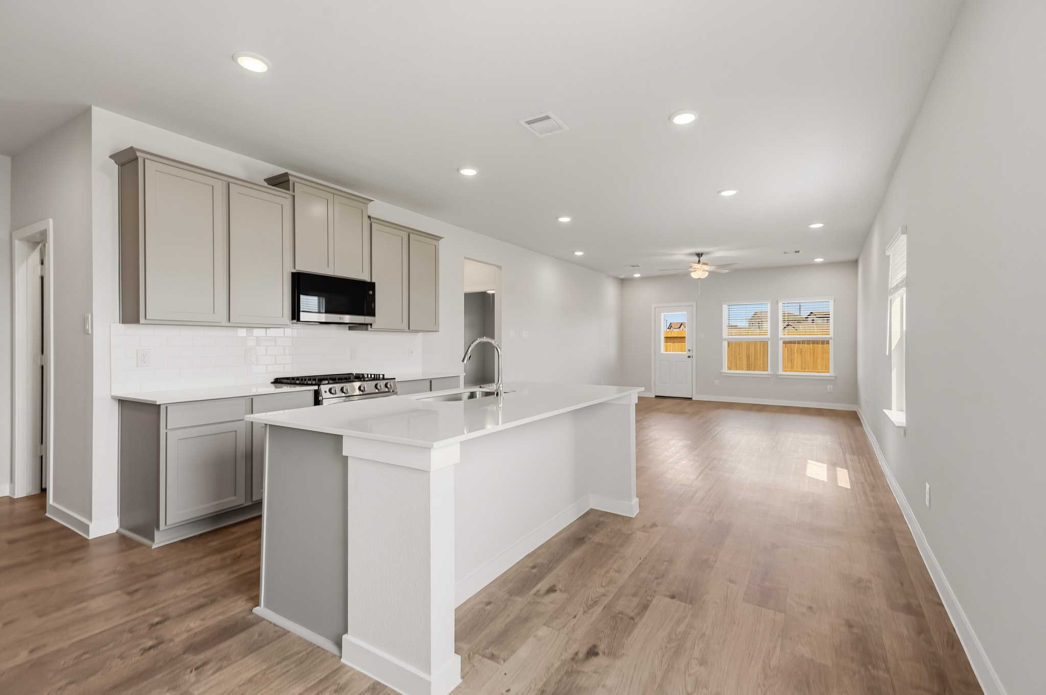 A kitchen with white cabinets.