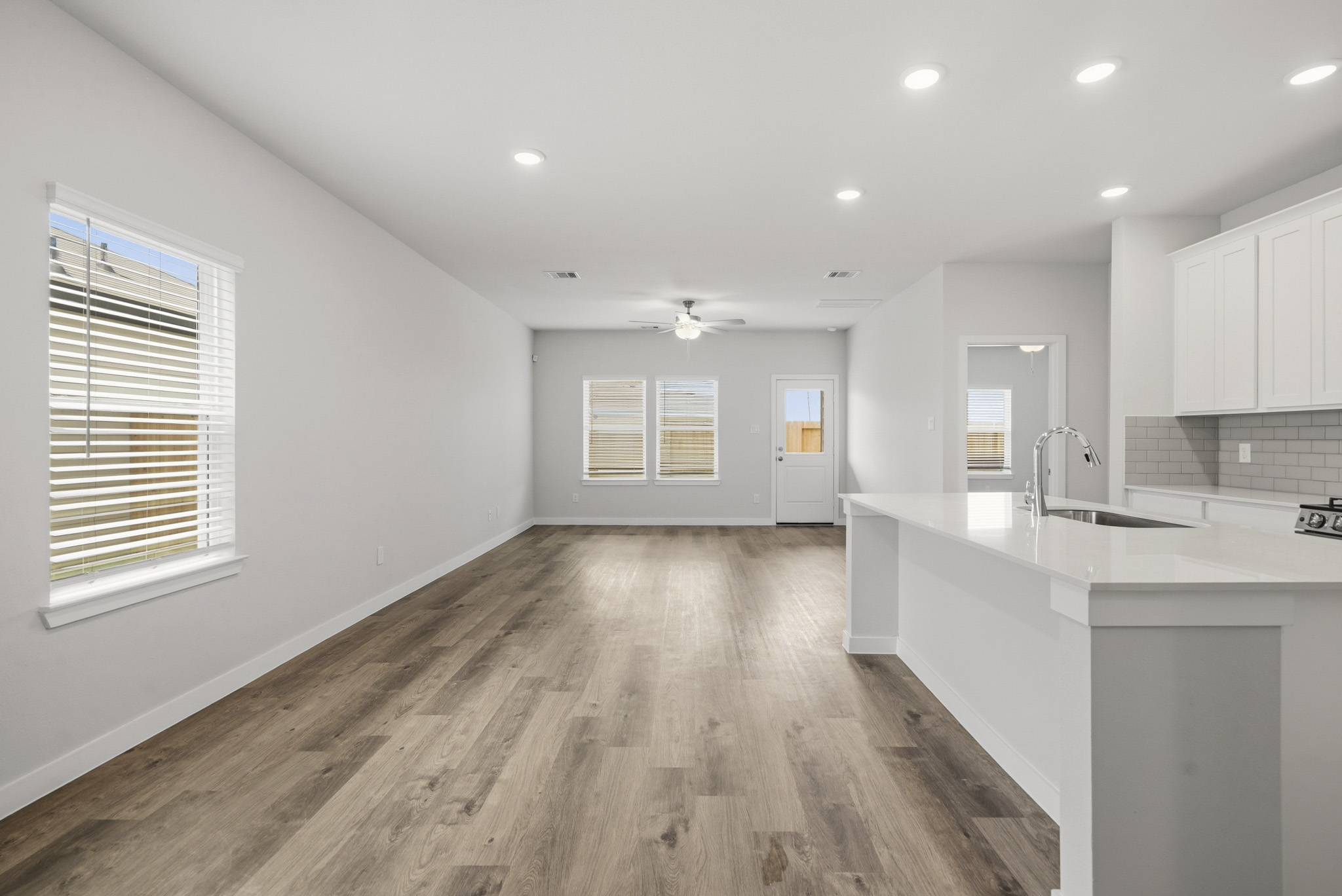 A kitchen with white cabinets.