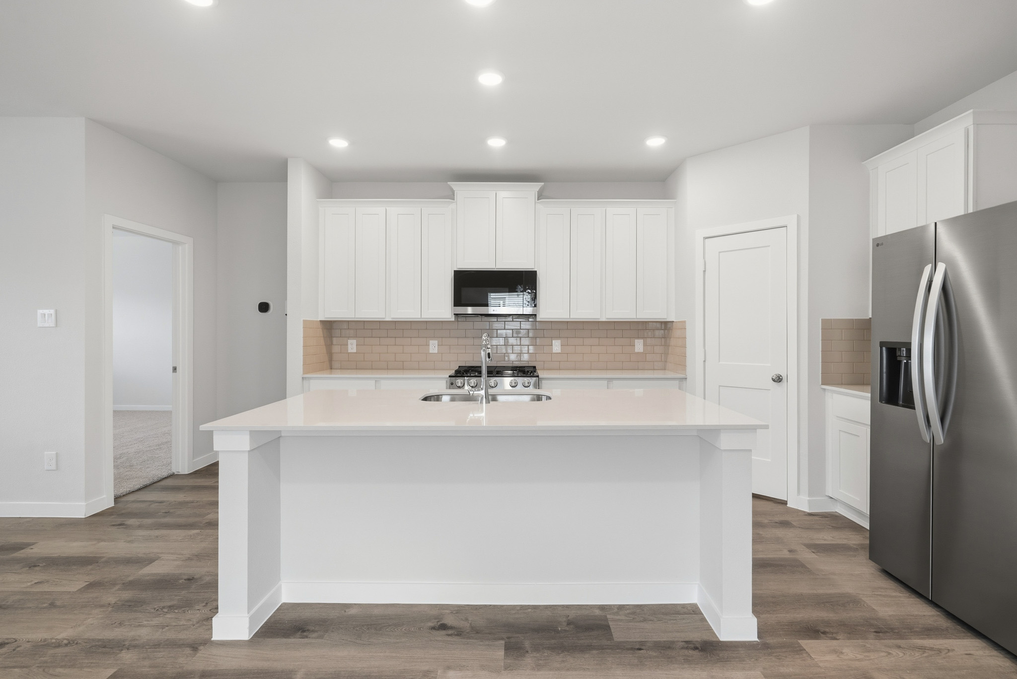 A kitchen with white cabinets.