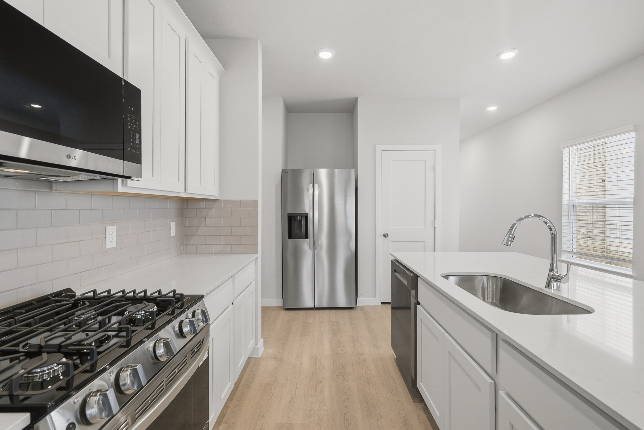A kitchen with white cabinets.