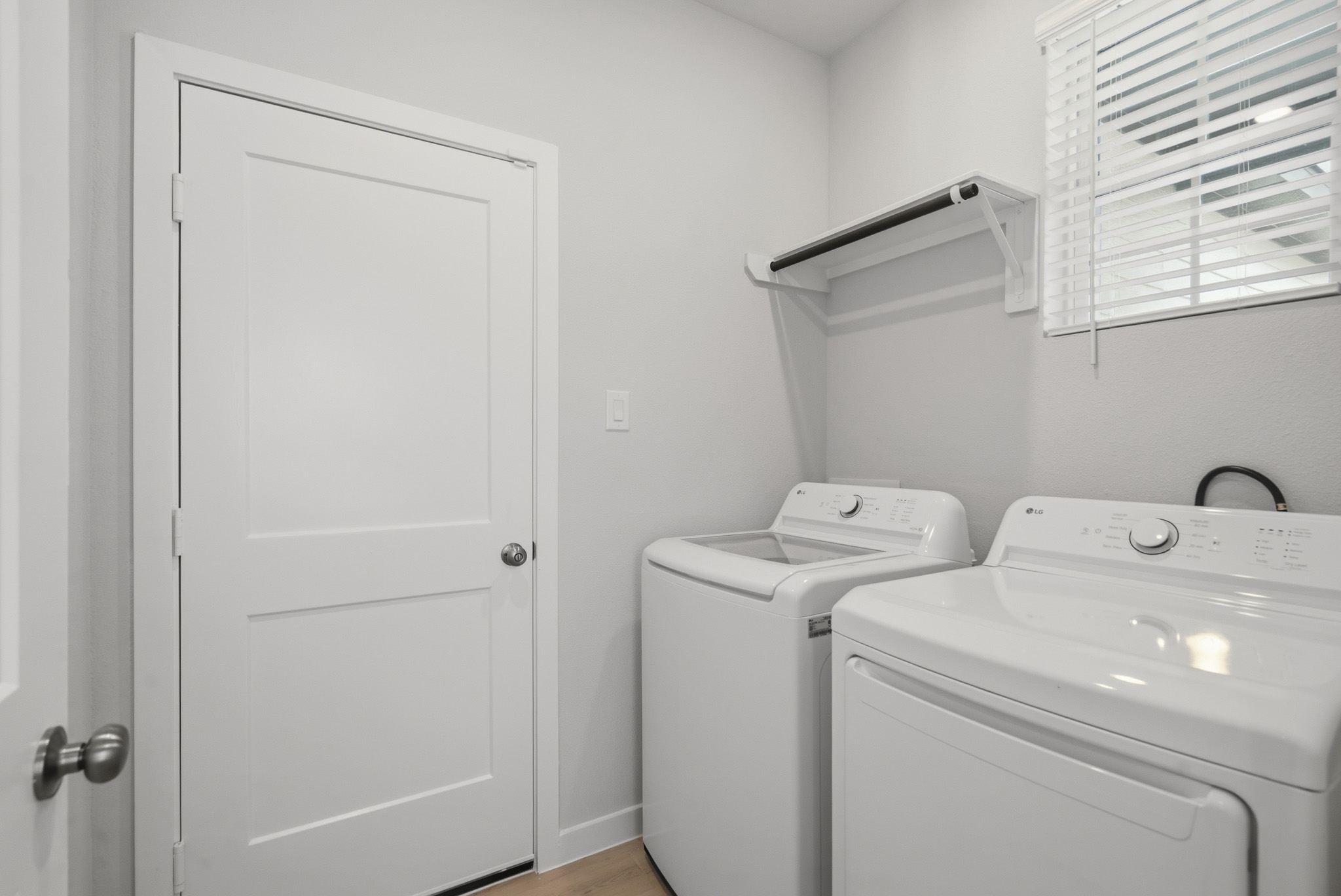 A washing machine and a dryer in a room.