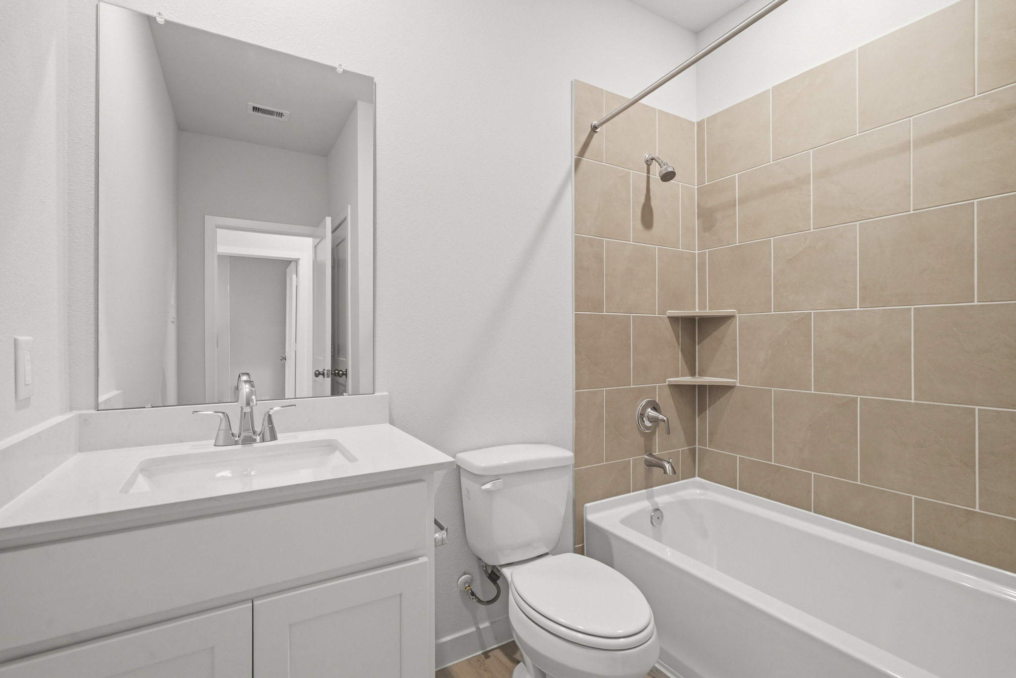 A bathroom with a tub sink and toilet.