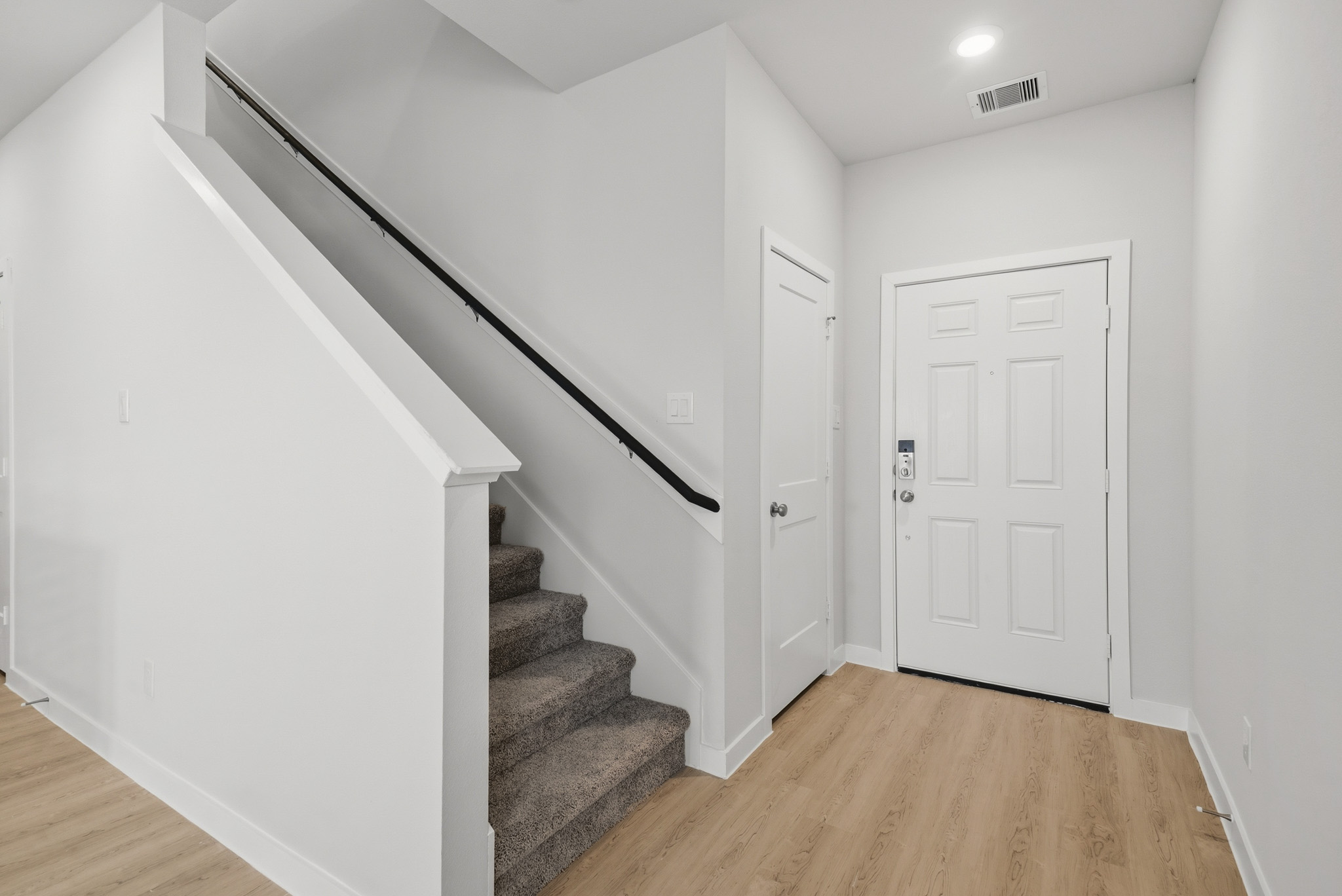 A staircase with white doors.
