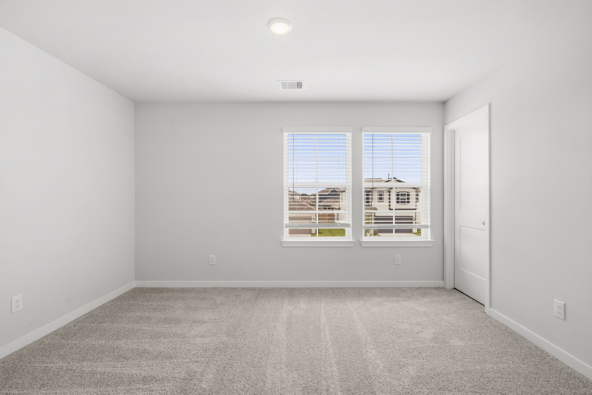 A room with a window and a door.