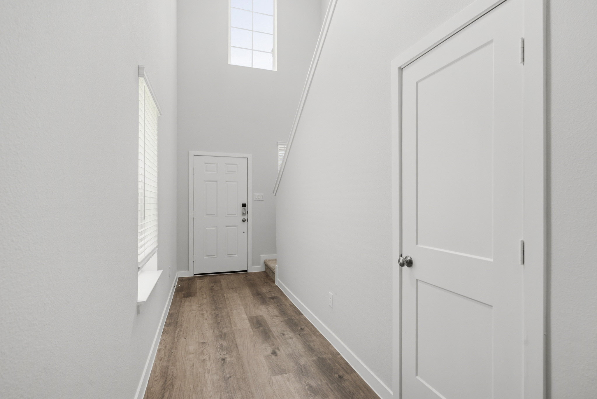 A hallway with white doors.
